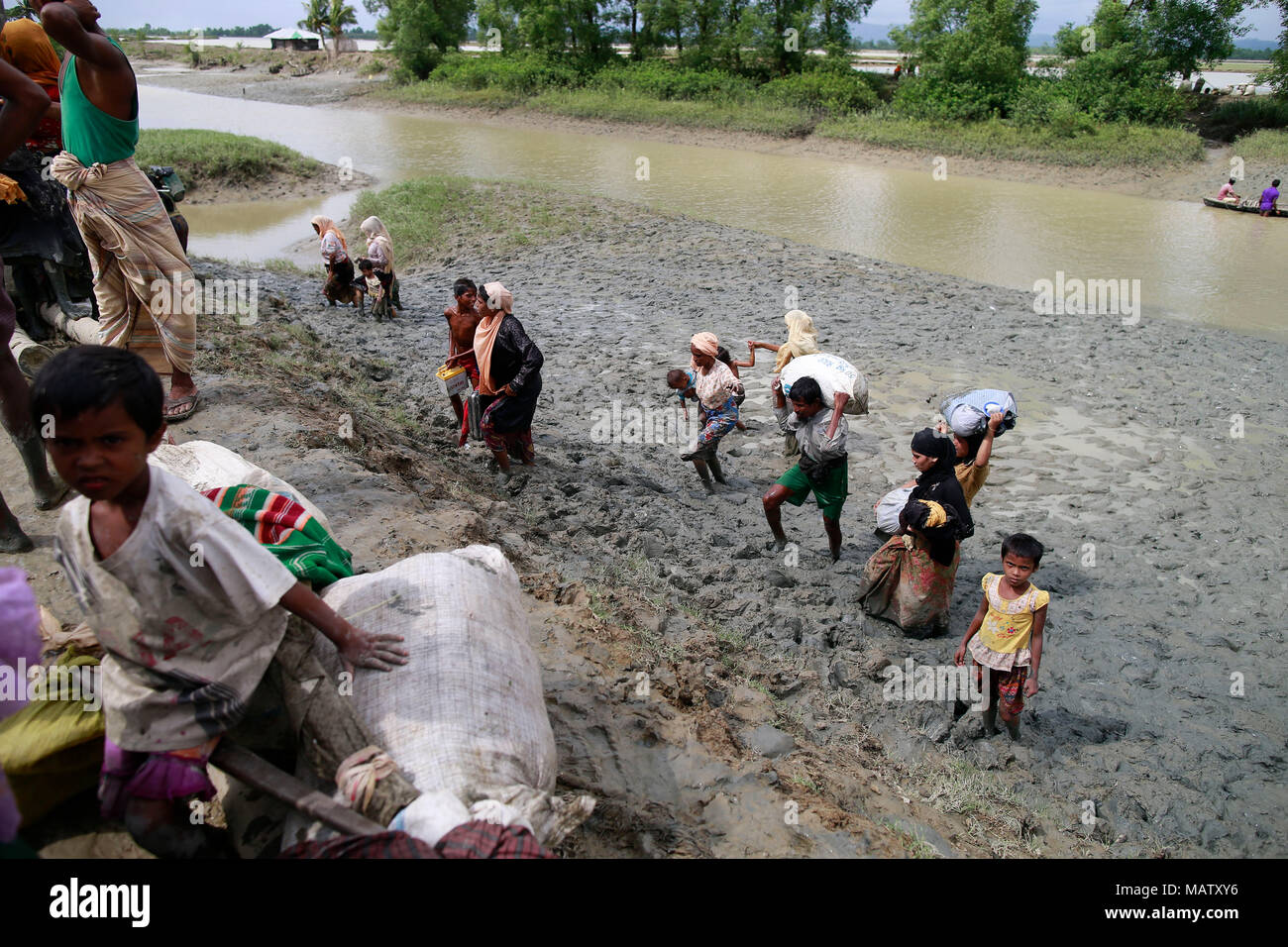 Rohingya muslims reaches the Bangladesh border after crossing a creek of the Naf river at Teknaf, Bangladesh. Stock Photo