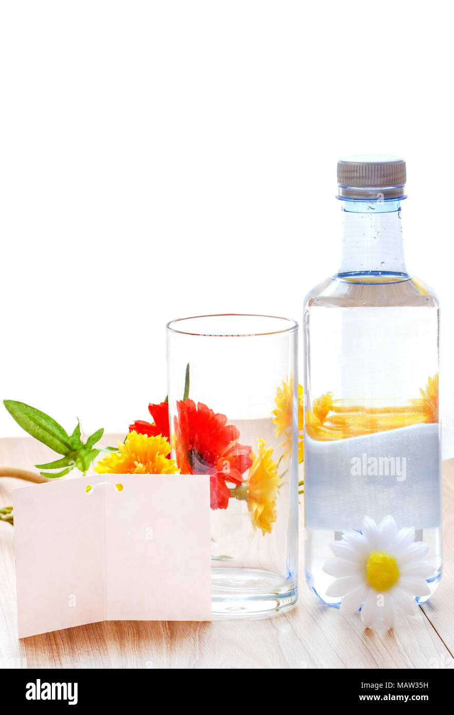 Water With Note water bottle and glass of water with white note paper and flower on ...