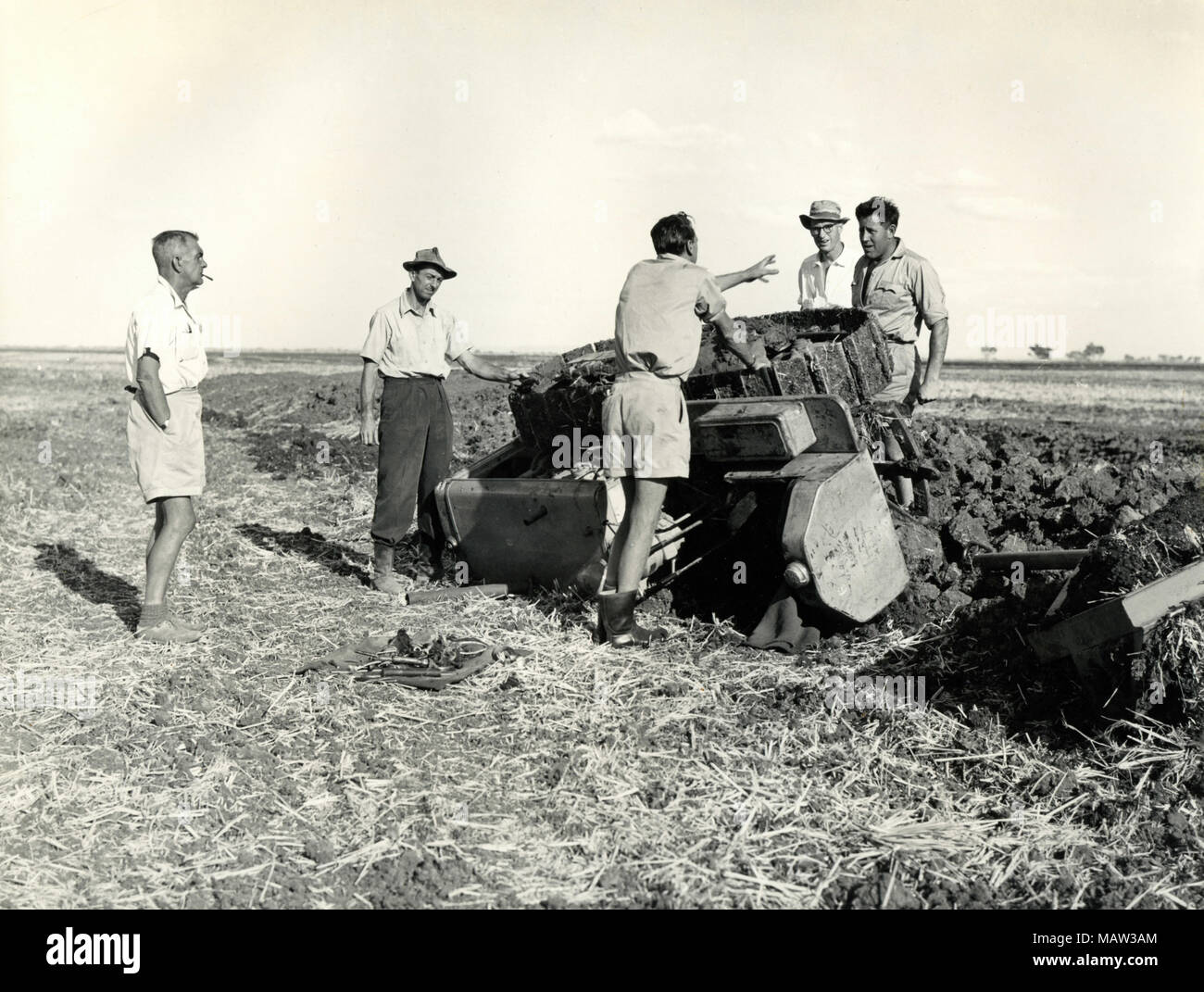 Men working the field with a tractor, Rhodesian Selection Trust, Kafue Pilot Polder, Zambia, South Rhodesia 1957 Stock Photo