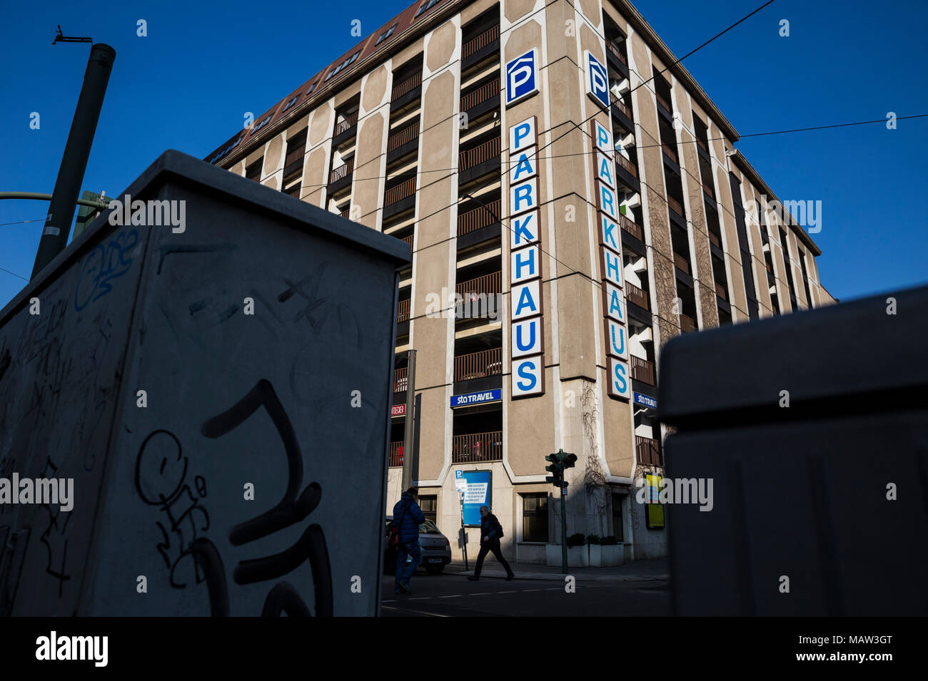 A Man Crosses The Road By A Car Park In Berlin Germany Stock