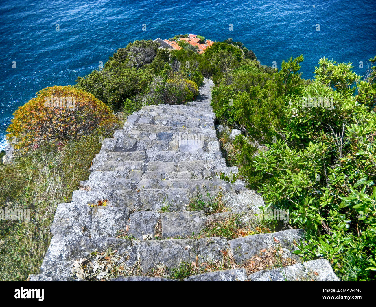 View of the old stone stairway leading to Monesteroli, a small village of fishermen in La Spezia Province, near Cinque Terre, Italy Stock Photo
