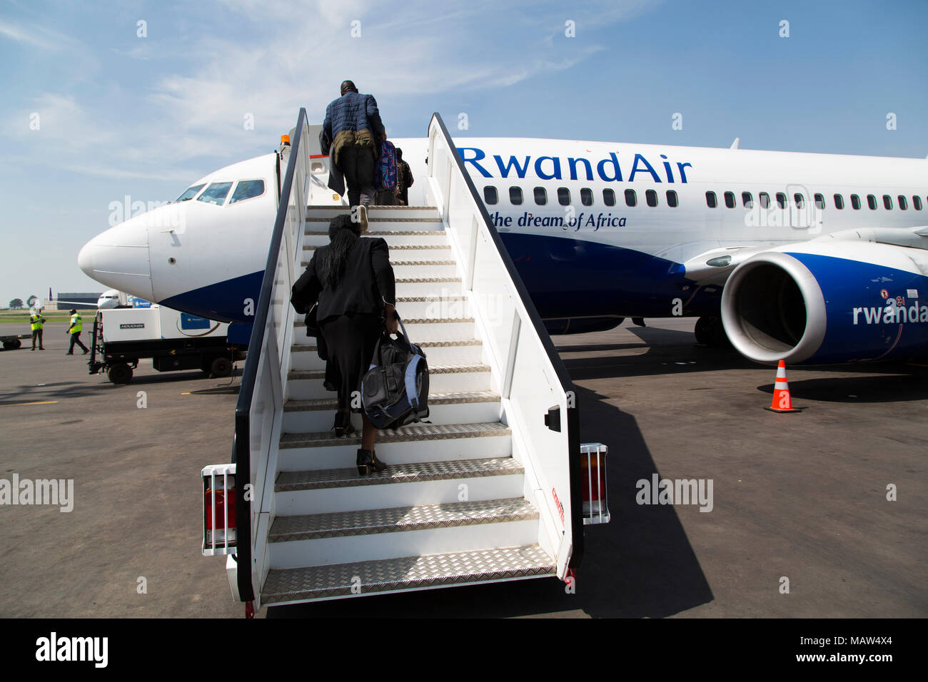 Travellers board a Rwandair aircraft at Kigali International Airport. The airport is the hub for Rwandair flights. Stock Photo