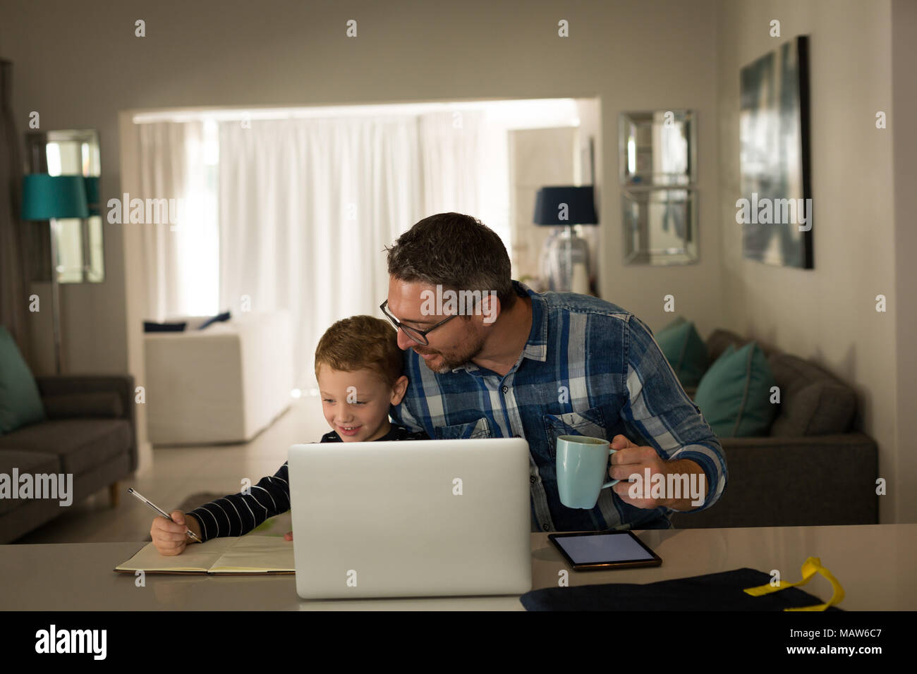 Father helping son with his homework Stock Photo