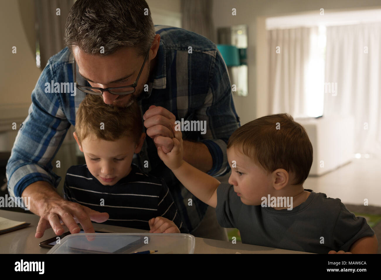 Father and his sons using digital tablet Stock Photo