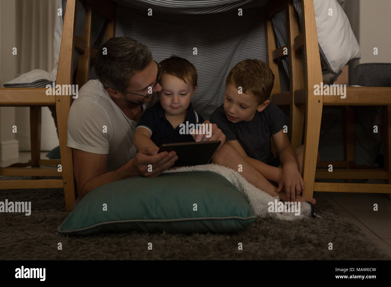 Father with his sons using digital tablet Stock Photo