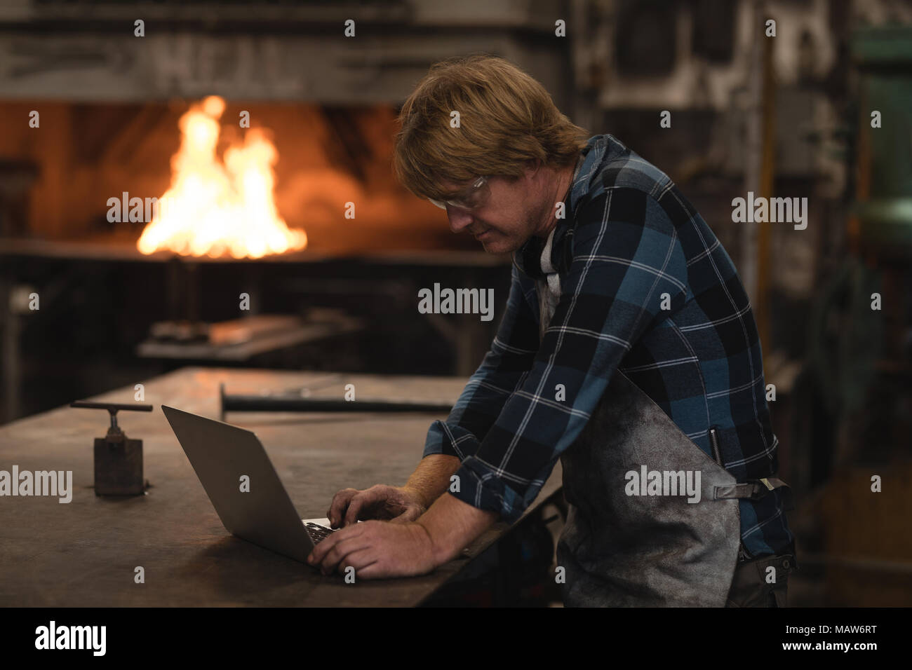 Attentive craftsman using laptop hi-res stock photography and images ...
