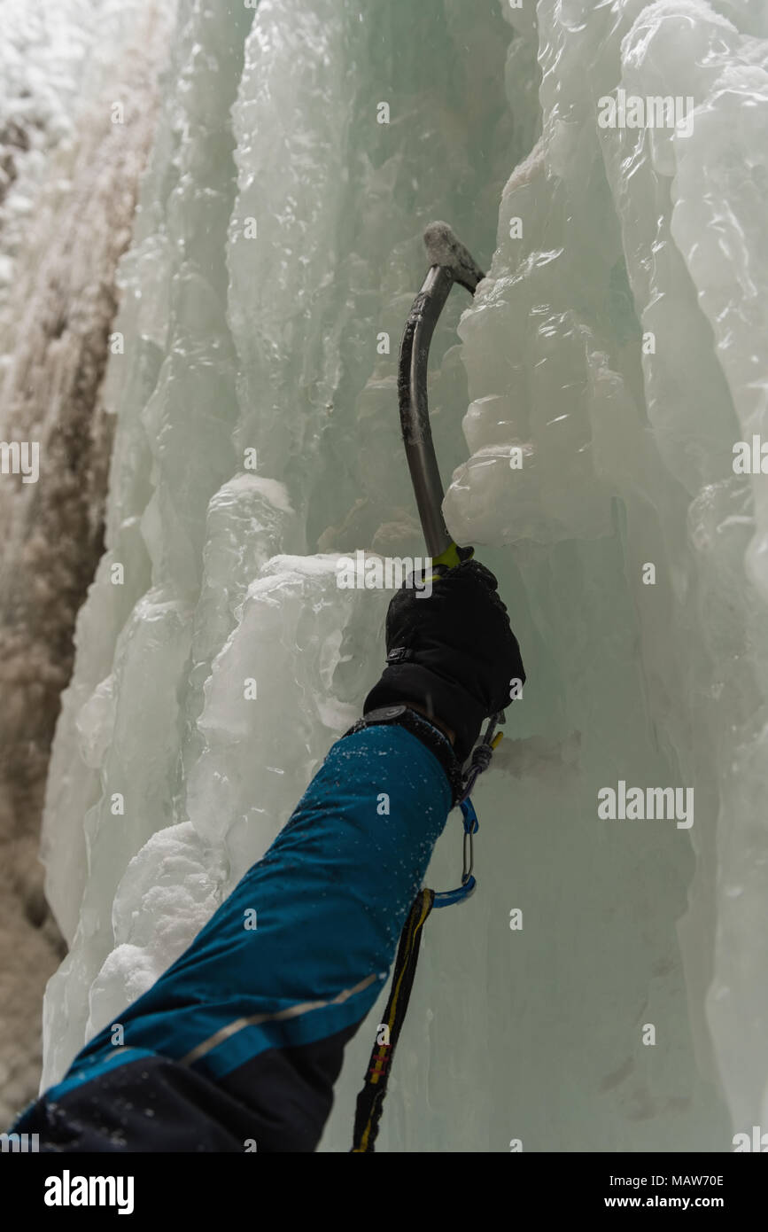 Male rock climber climbing ice mountain Stock Photo