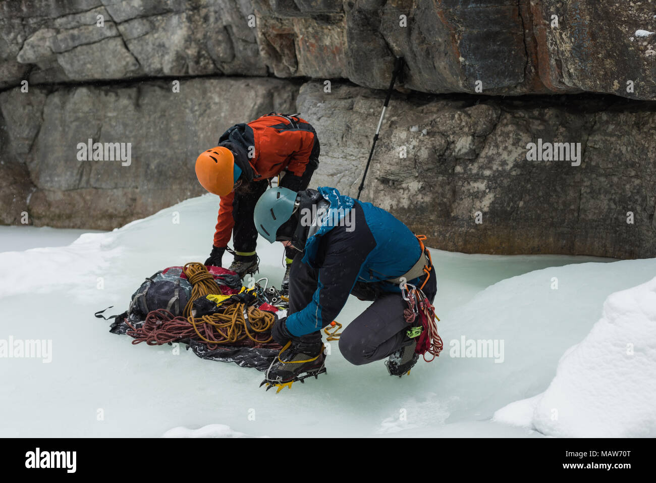 Male rock climber wearing crampons near rocky mountain Stock Photo