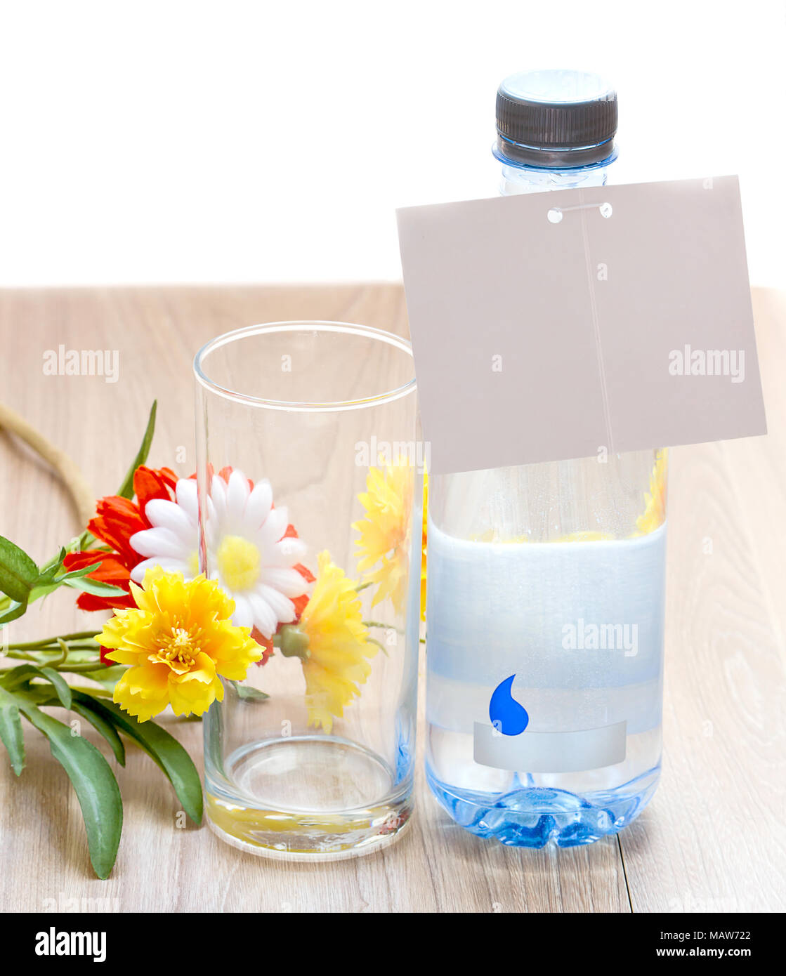 Water With Note water bottle and glass of water with white note paper and flower on ...