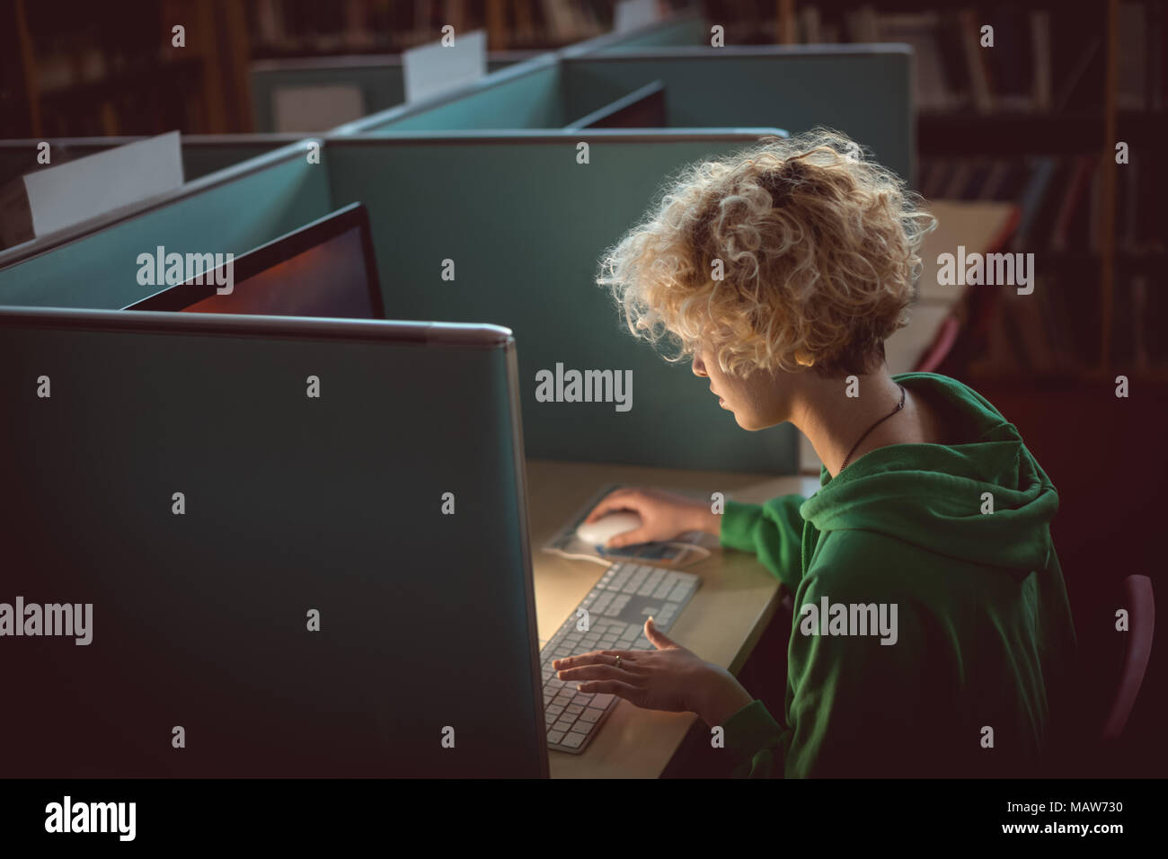Woman working on computer in library Stock Photo - Alamy