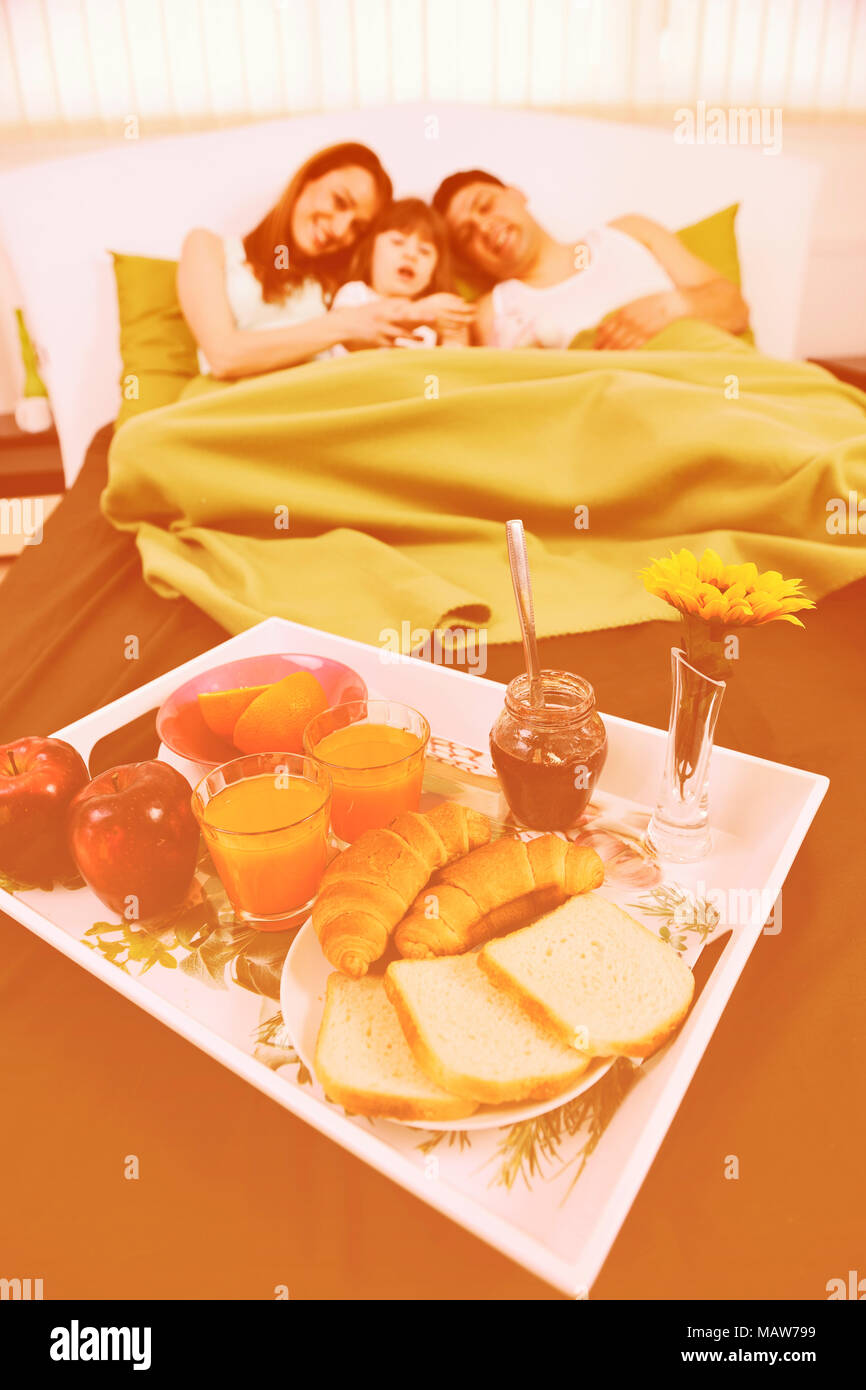 happy young family eat breakfast in bed at morning Stock Photo Alamy