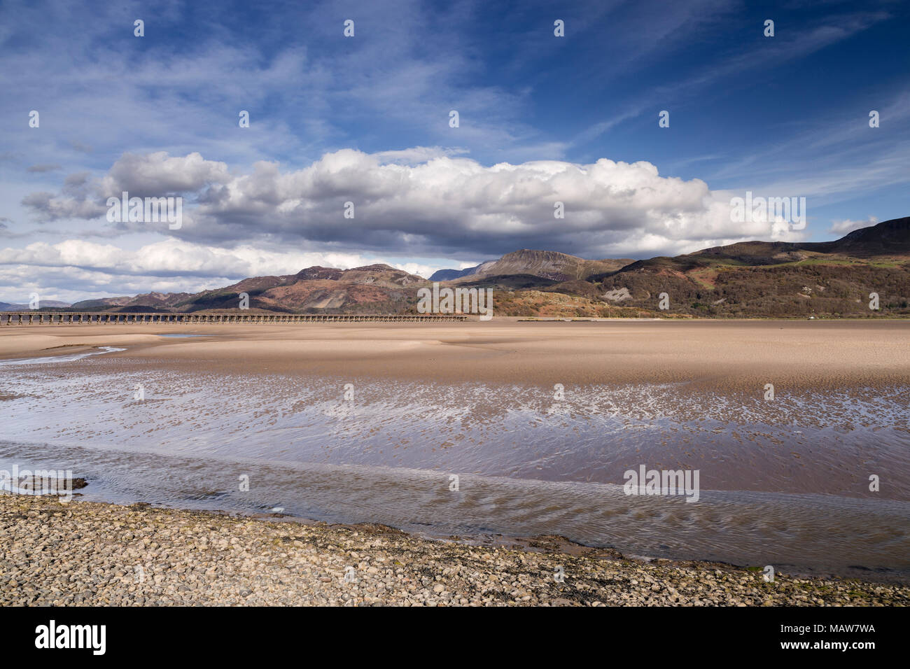 Sand at low tide on the Mawddach Estuary, Snowdonia, Wales, with mountains and clouds in the background Stock Photo