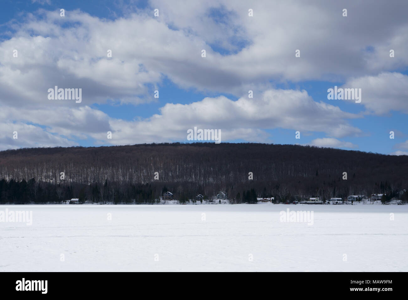 Large blue sky with white clouds on the lake at spring time during a beautiful day. Stock Photo