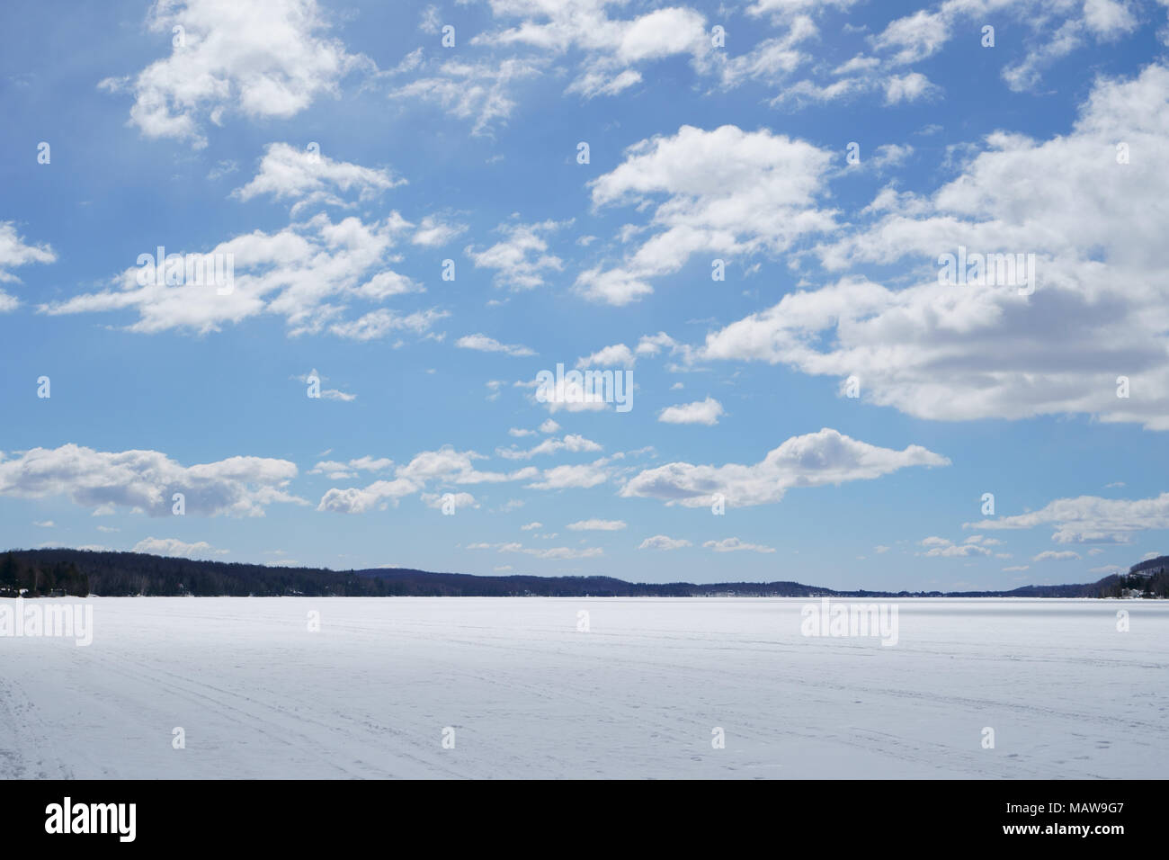 Large blue sky with white clouds on the lake at spring time during a beautiful day. Stock Photo