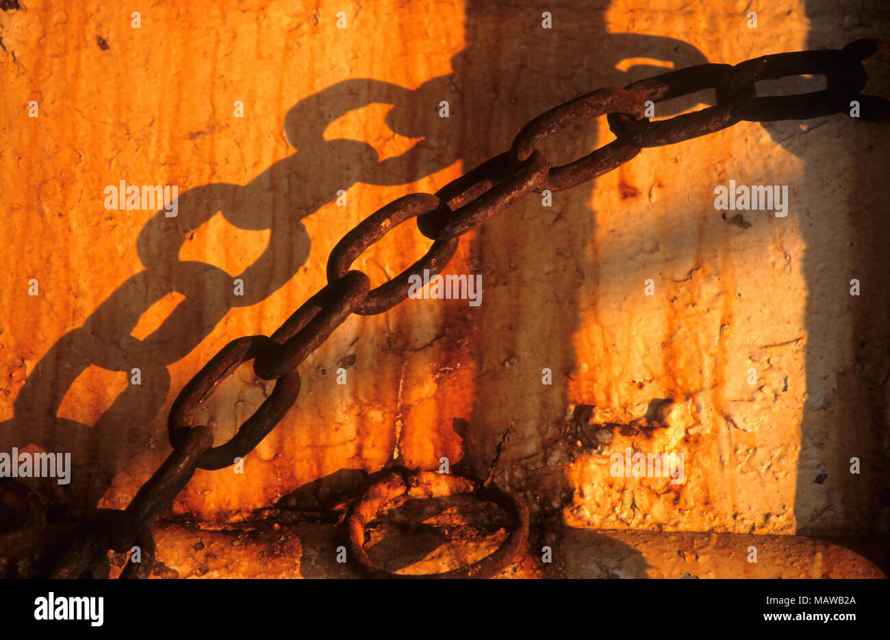 A chain crosses the rusting hull of a fishing boat on the New Bedford, waterfront, Massachusetts, USA Stock Photo