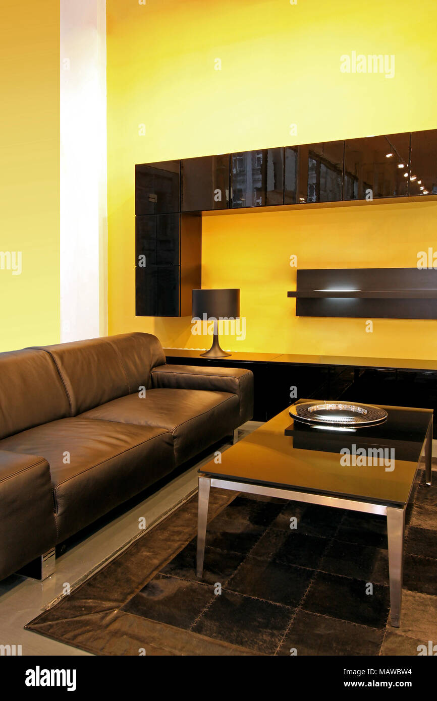 Modern Living Room With Leather Sofa And Yellow Walls Stock Photo Alamy