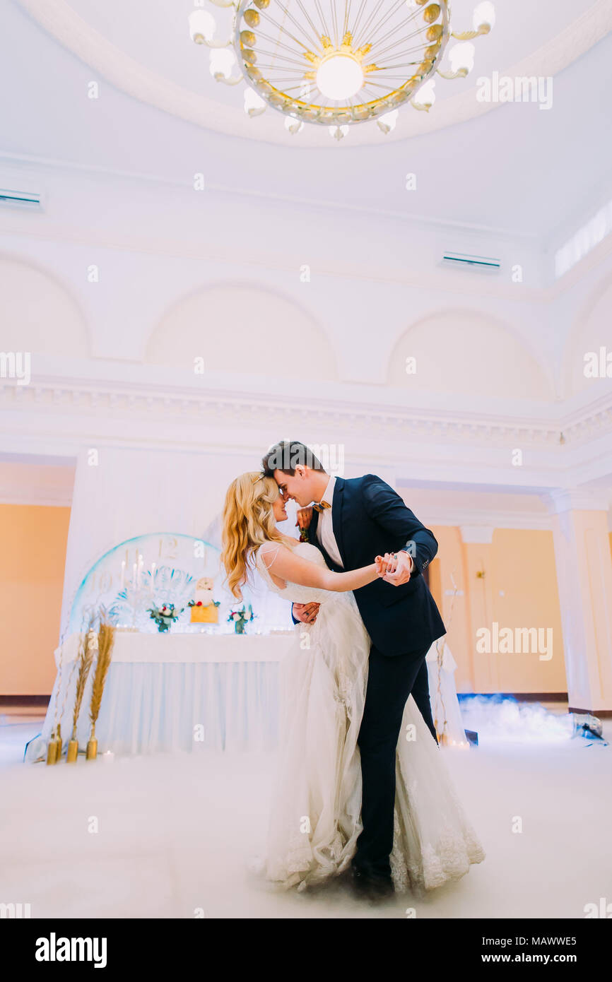 Happy young bride and groom dance in the wedding hall Stock Photo - Alamy