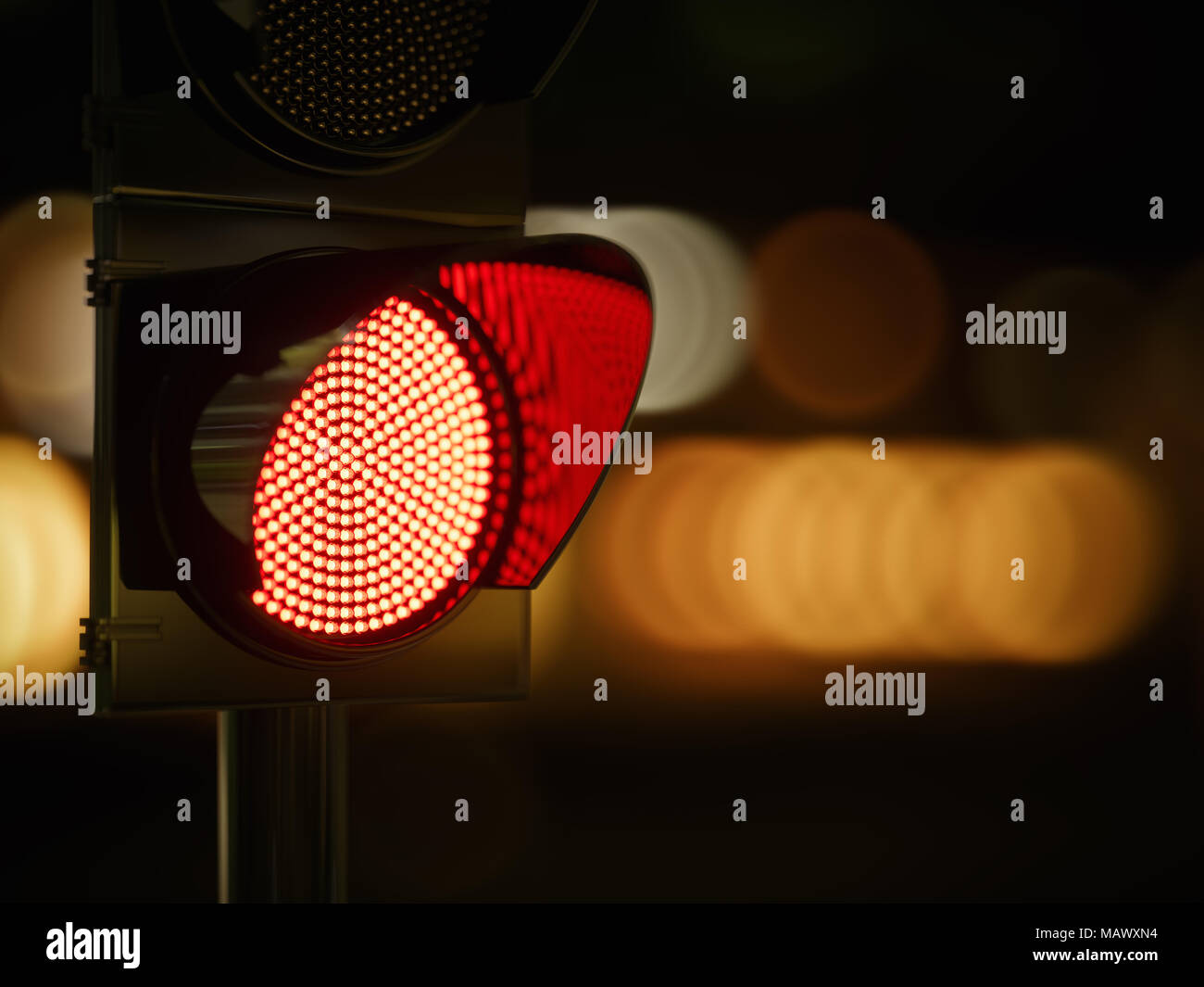 Red traffic light in the dark night city street. 3d rendering illustration Stock Photo