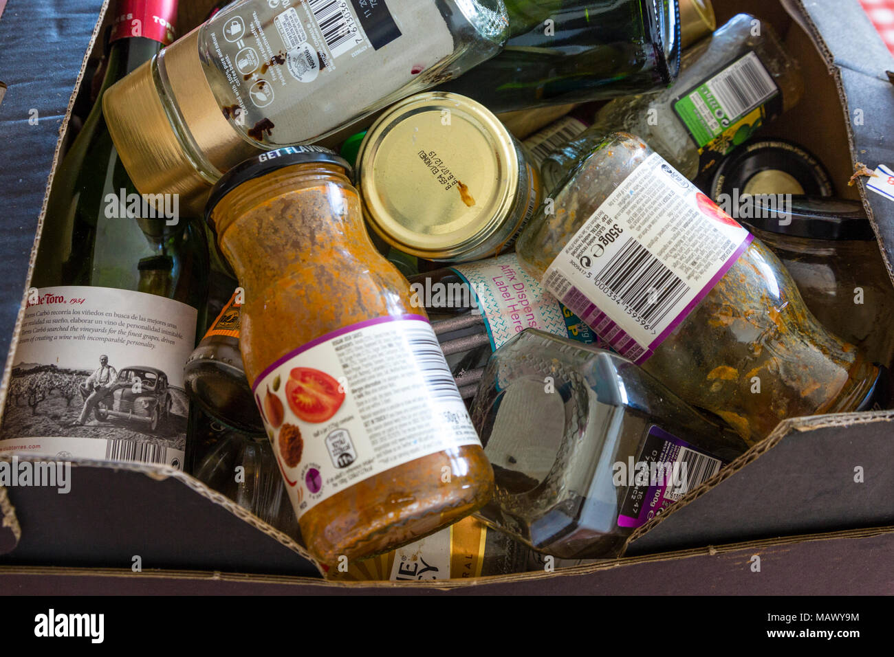 Cardboard box with glass bottles and jars for recycling Stock Photo