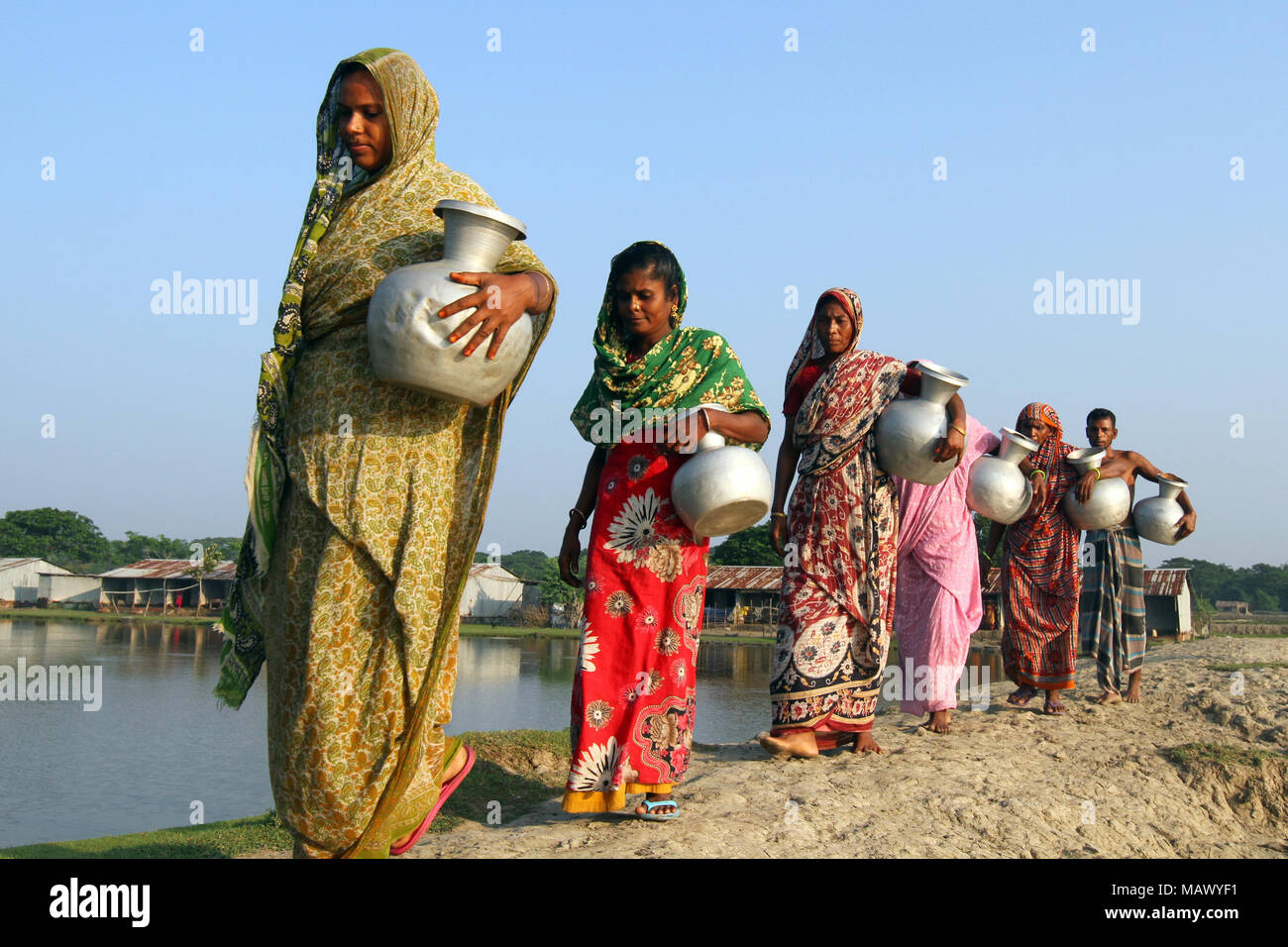 Khulna, Bangladesh October 08, 2014 Bangladeshi women carry drinking