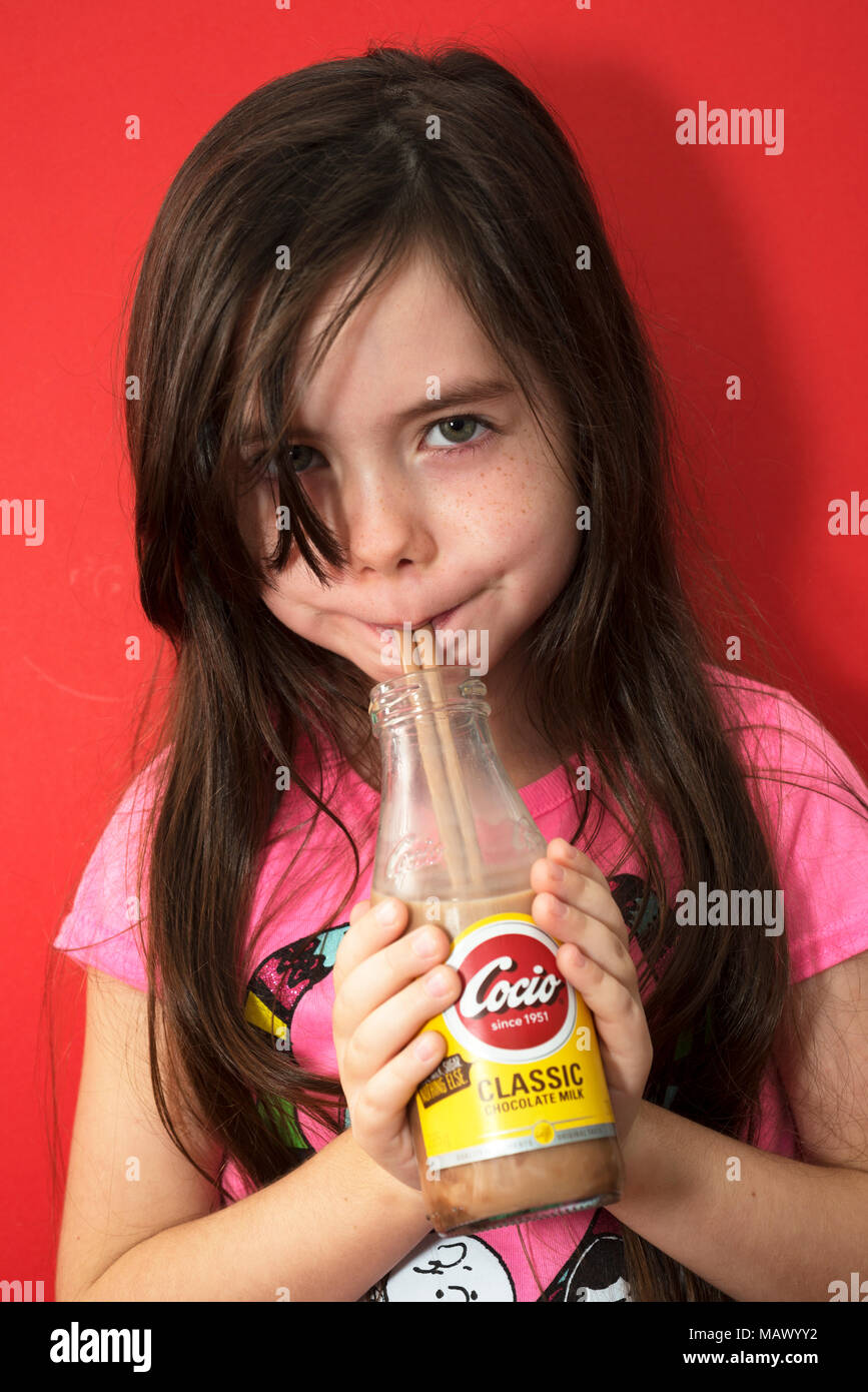 Young girl drinking Cocio chocolate milk Stock Photo