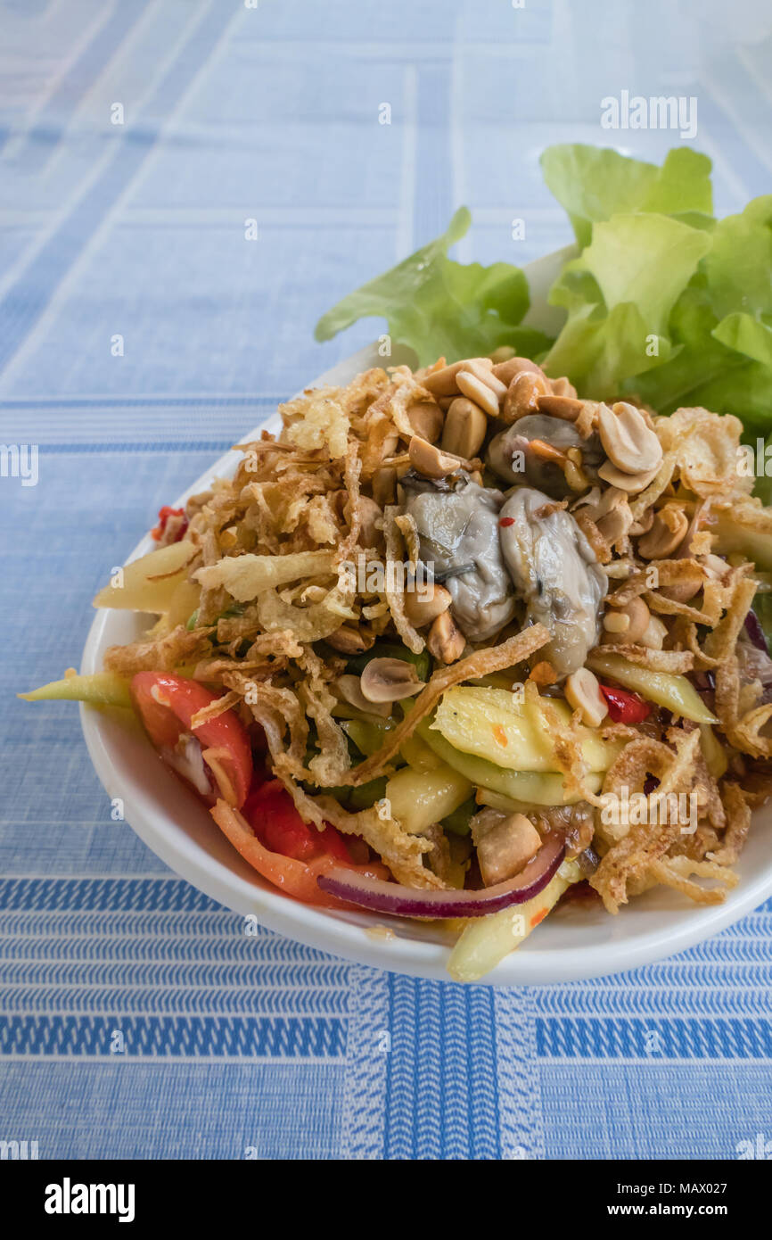 spicy yellow mango salad with fresh oyster , shallot garnish and crispy shallot Stock Photo Alamy