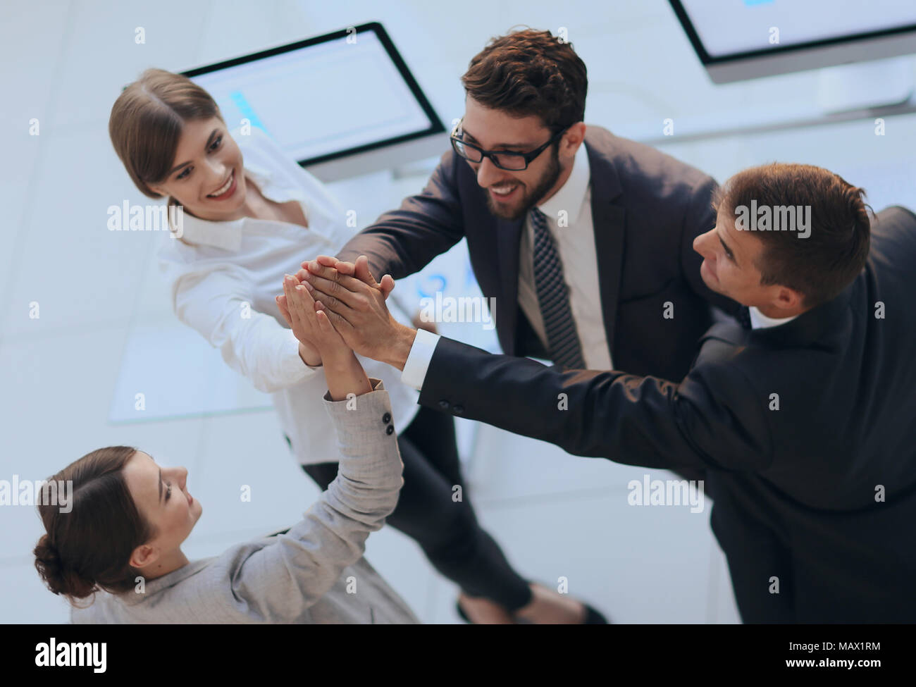 successful business team giving each other a high-five, standing in the ...