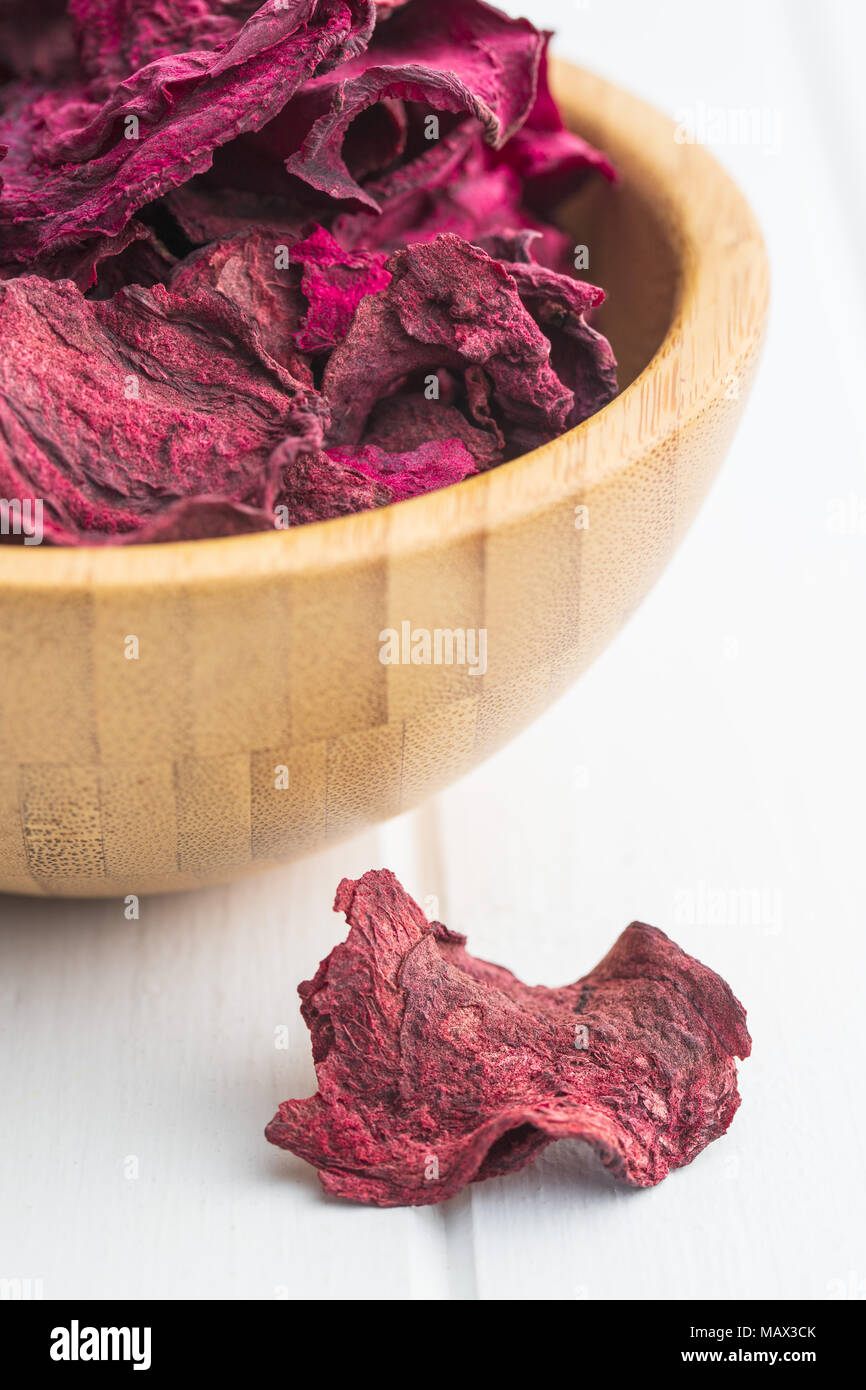 Dried beetroot chips on white table. Stock Photo