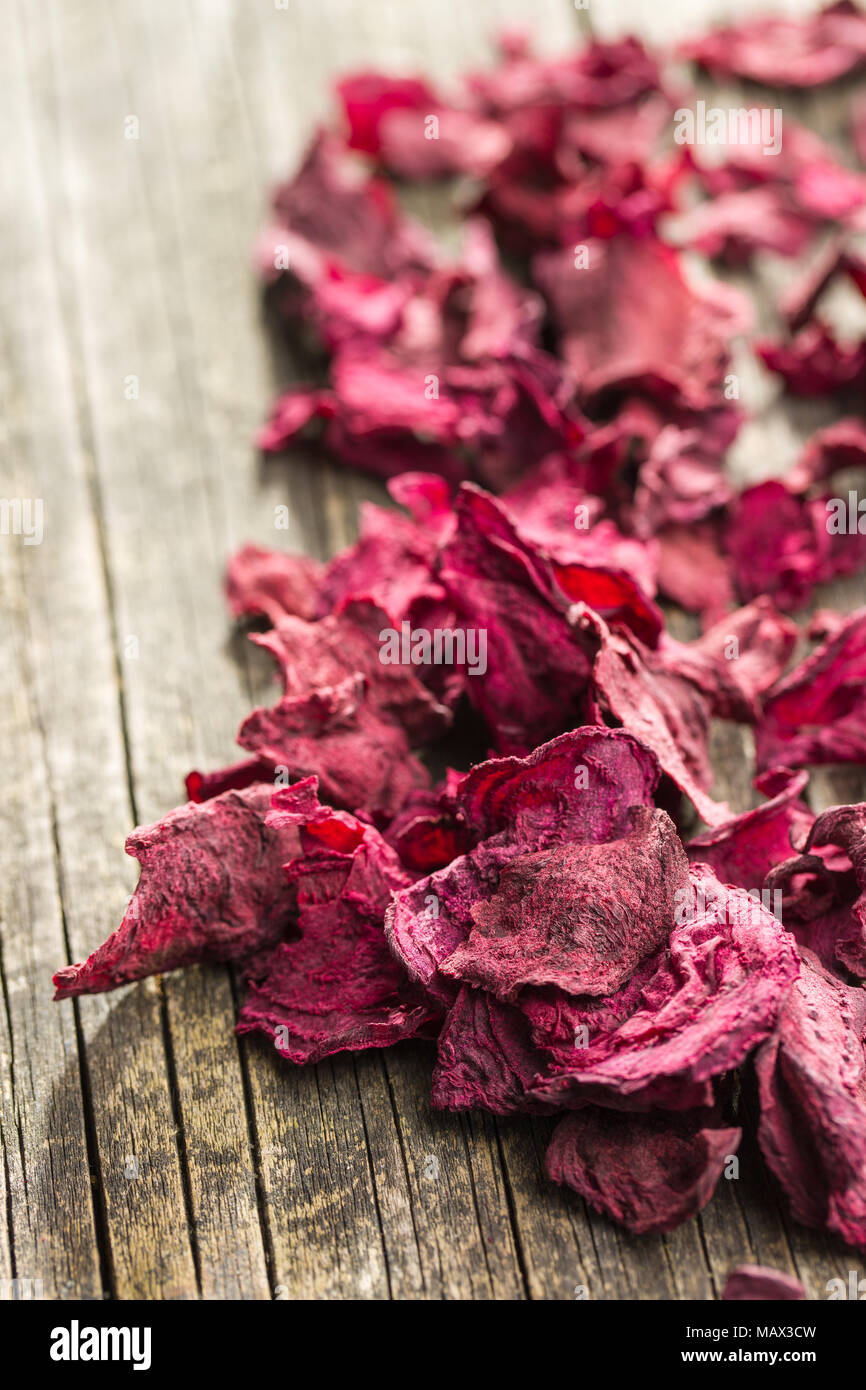 Dried beetroot chips on old wooden table. Stock Photo