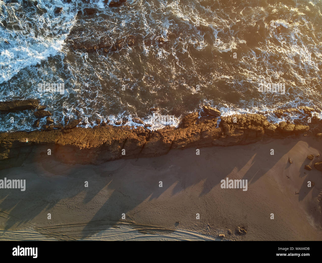 Ocean shore in sunset time aerial above drone view Stock Photo