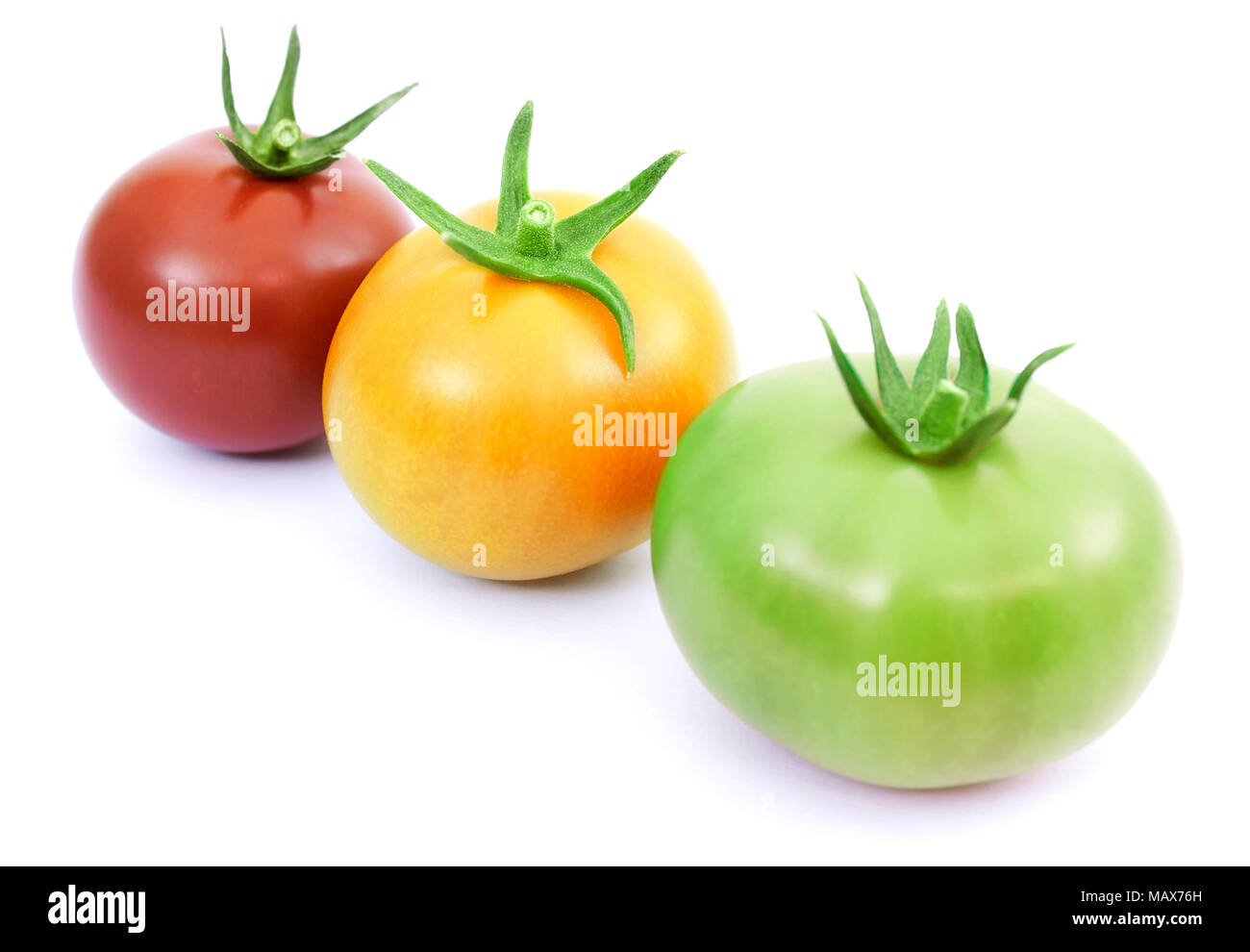 Tomatoes red, yellow and green isolated on white Stock Photo - Alamy