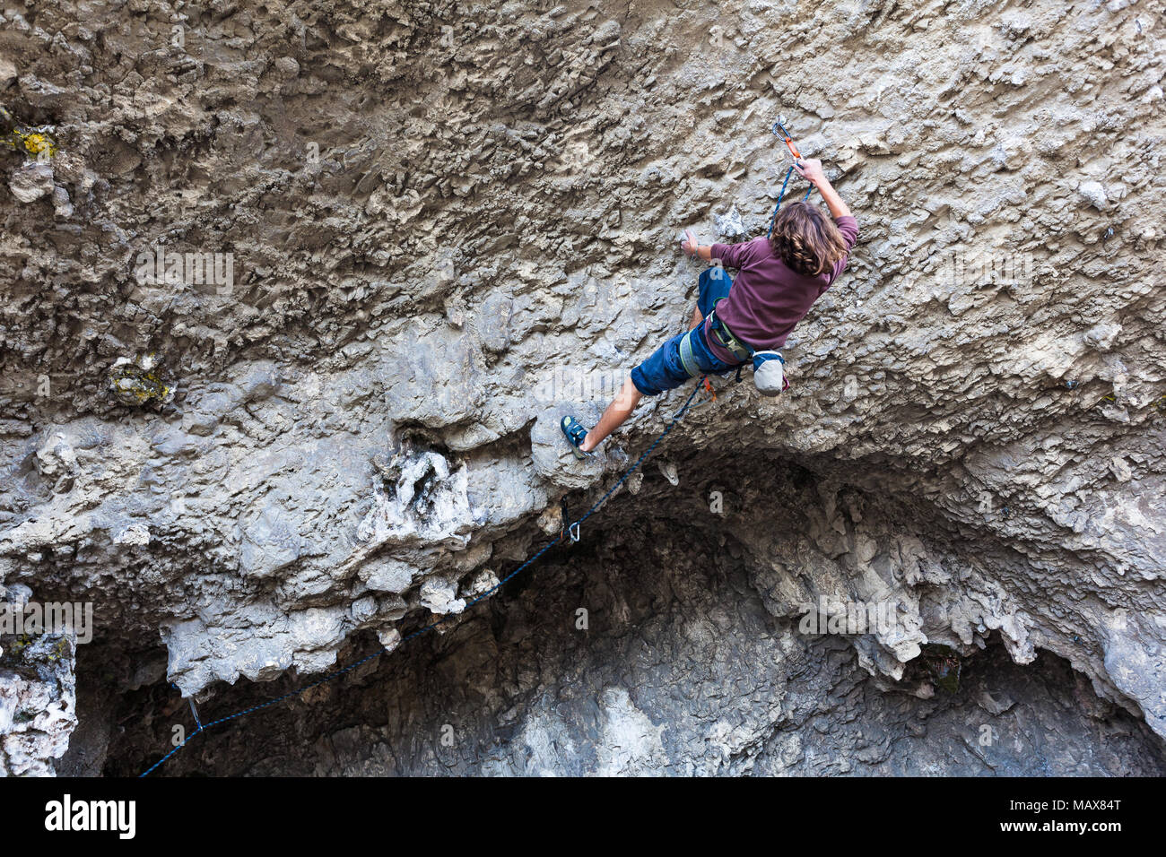 Young climber climbing the rock walls of a cave, Ecuador Stock Photo