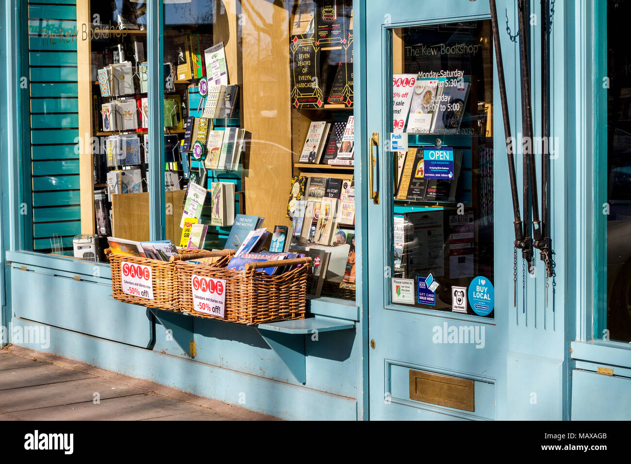 The Kew Bookshop, book shop, book store front,  Kew, London UK basket of books, window display books, window book display read reading concept Stock Photo
