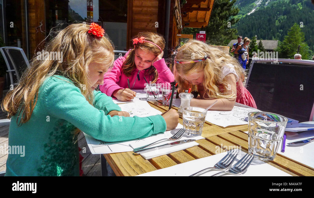 Children, kid eating lunch, al fresco, on a bright sunny day,  Seiss Alps, Switzerland Stock Photo