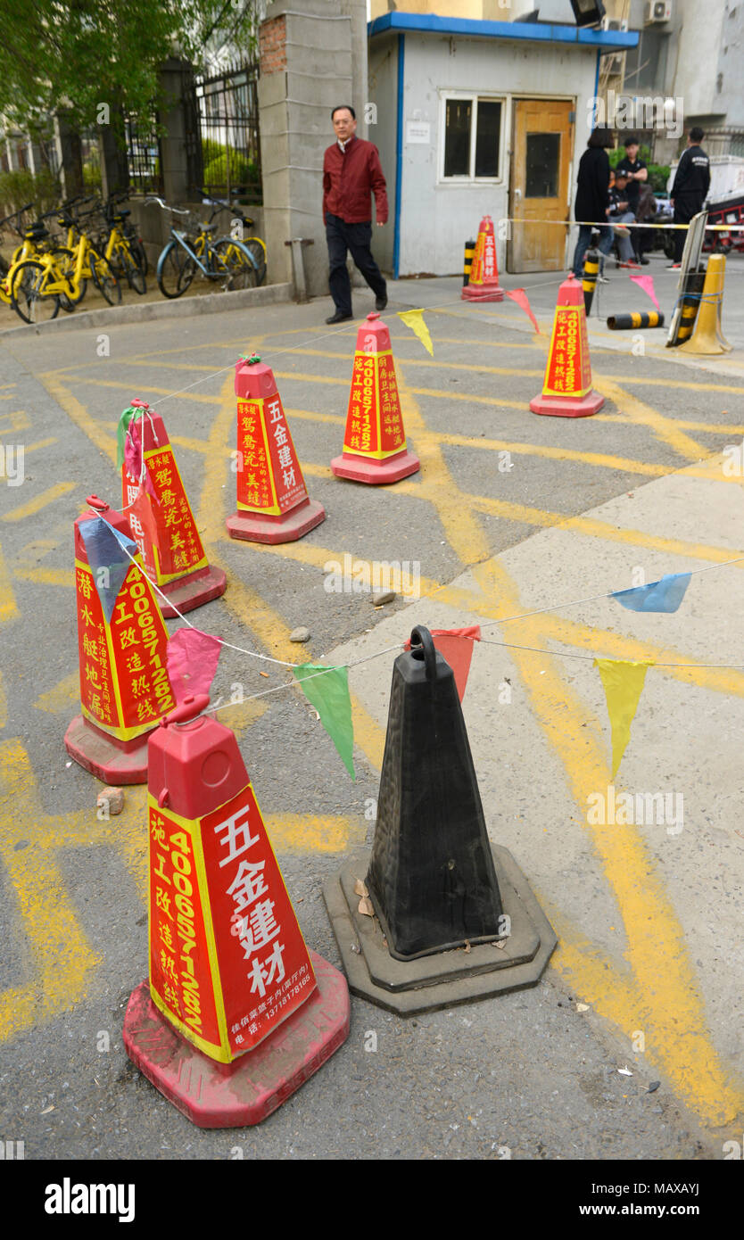 Entrance to a residential compound peppered with bollards in central western Beijing, China Stock Photo