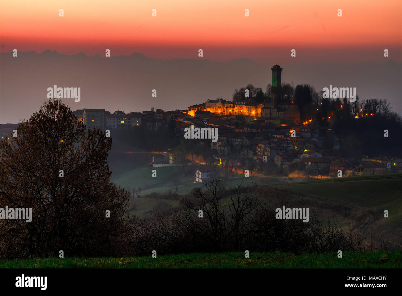 Night falls on Murazzano and its medieval watchtower in the Langhe, Piedmont. Stock Photo
