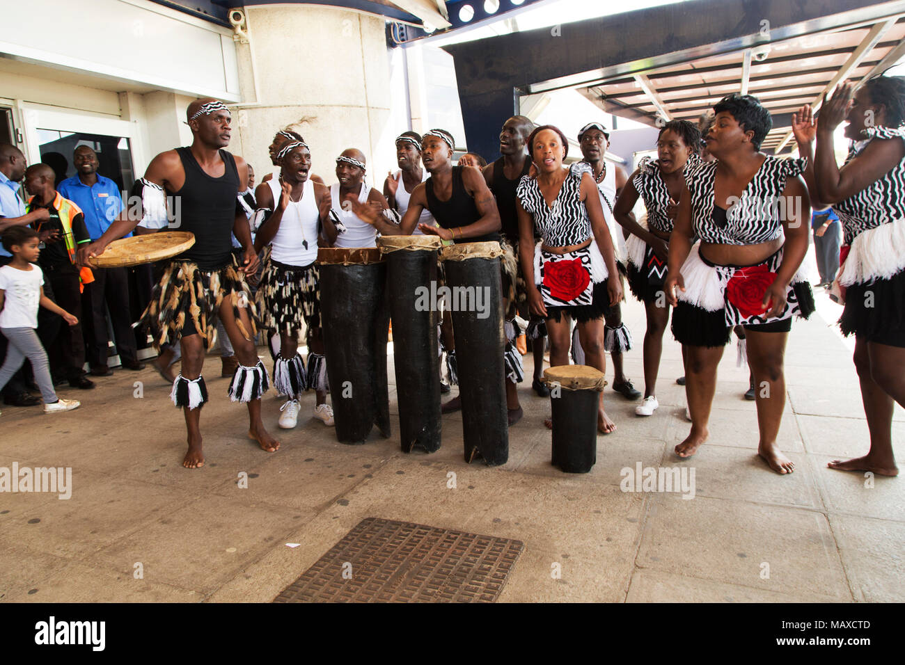 Dancers welcoming arriving travellers at Robert Gabriel Mugabe International Airport in Harare, Zimbabwe. The group performs traditional tribal dances Stock Photo