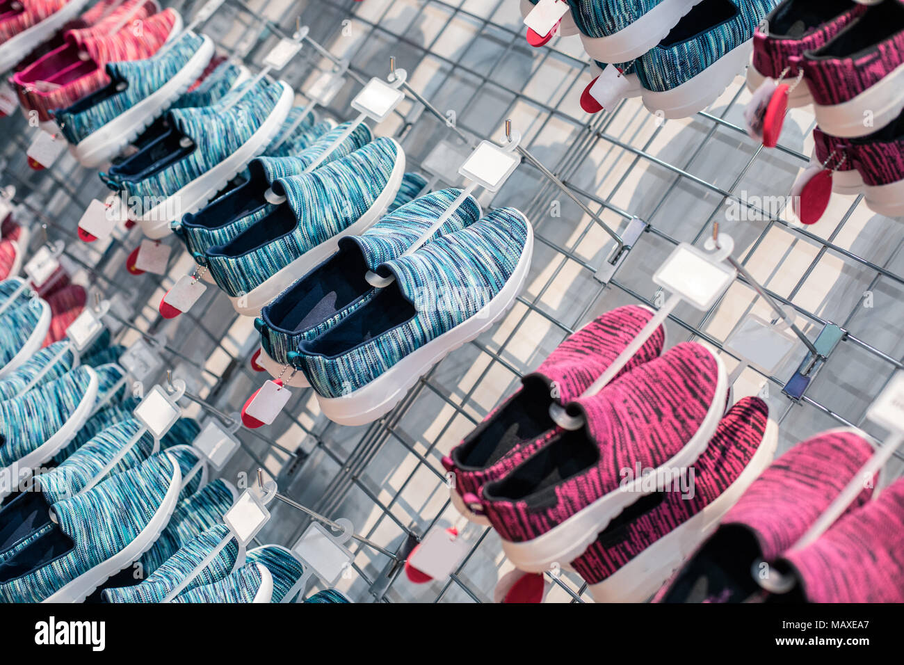 Rows of colorful athletic footwear in the sports shoe store marketplace. Stock Photo