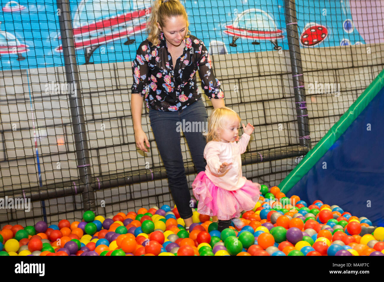 mother with daughter in ball pool at playground, Ottawa, Ontario, Canada Stock Photo