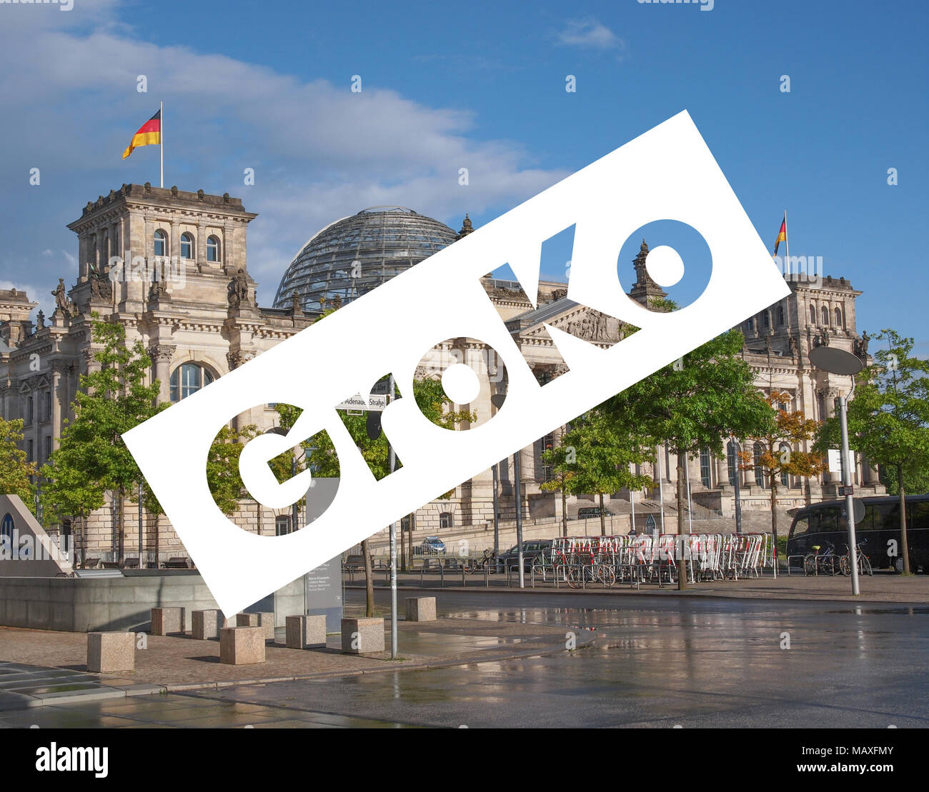 GroKo (short for Grosse Koalition, meaning Grand Coalition) superimposed to the Reichstag houses of parliament in Berlin, Germany Stock Photo