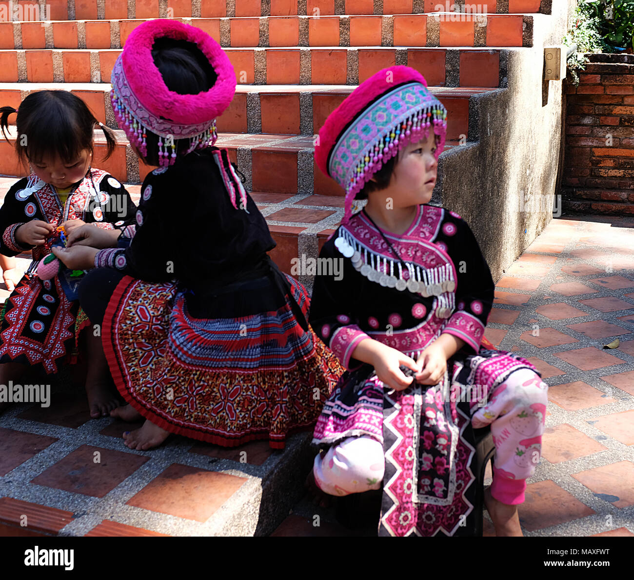 Three girls in traditional costume, Chiang Mai, Thailand Stock Photo