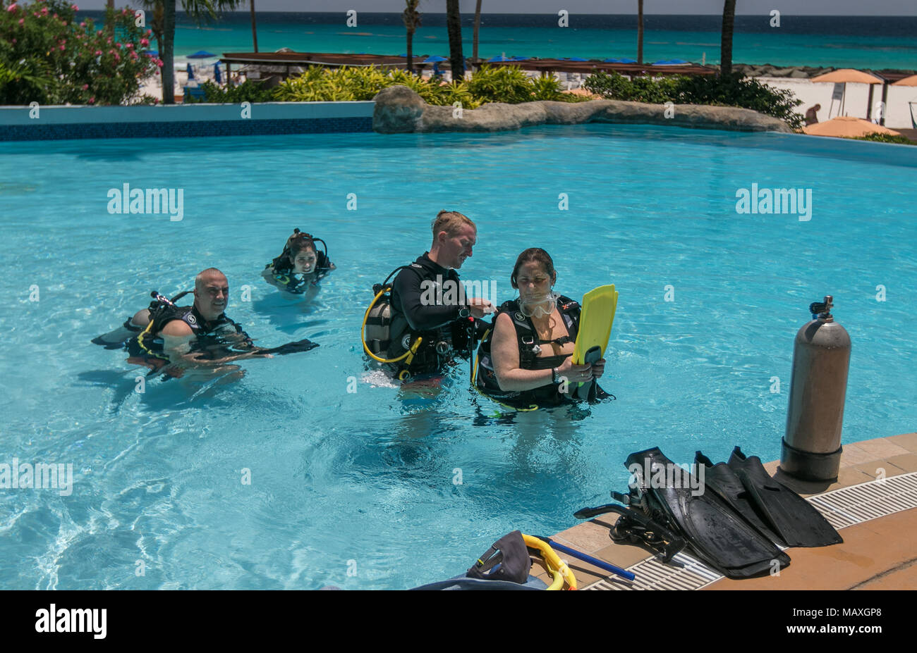 Bridgetown, Barbados, March 19, 2018: People are taking initial SCUBA lessons in a hotel pool. Stock Photo