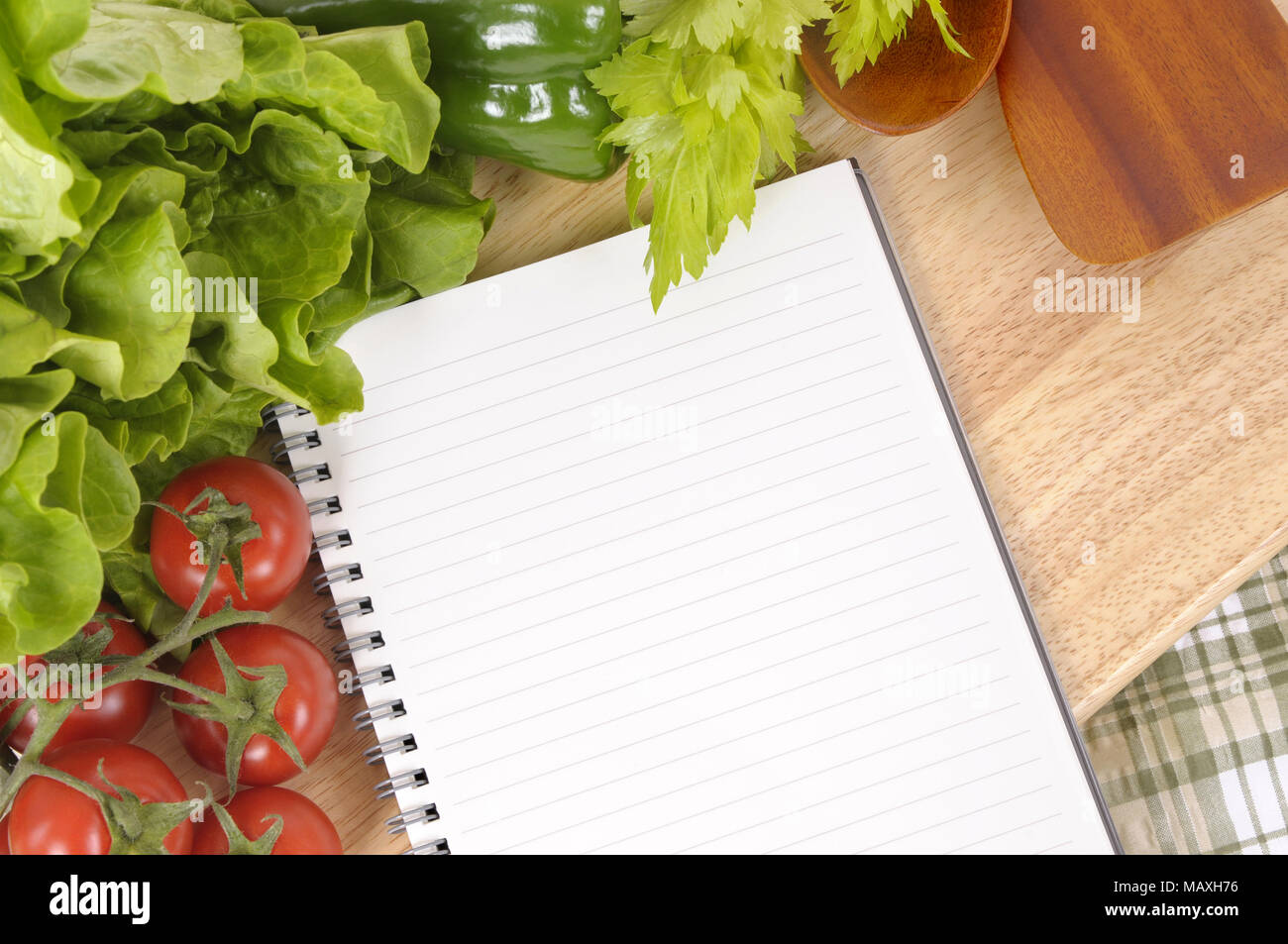 https://c8.alamy.com/comp/MAXH76/selection-of-salad-vegetables-with-blank-recipe-book-or-shopping-list-on-a-green-check-tablecloth-with-wood-chopping-board-MAXH76.jpg