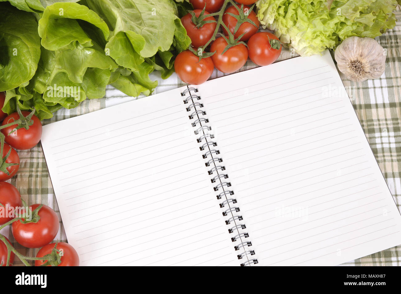https://c8.alamy.com/comp/MAXH87/selection-of-salad-vegetables-with-blank-recipe-book-or-shopping-list-on-a-green-check-tablecloth-MAXH87.jpg