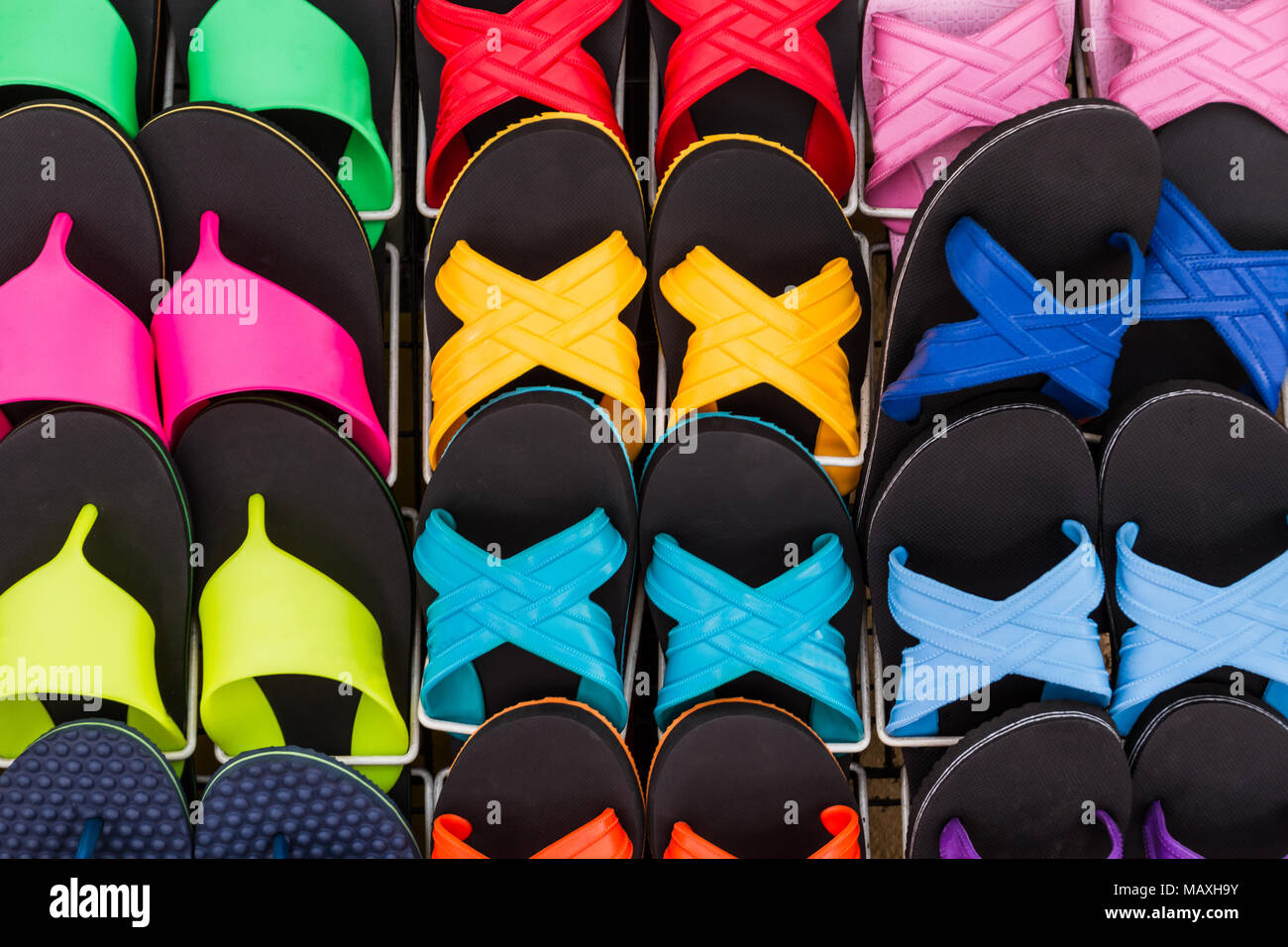 Colorful of flat shoes hanging on shelf for sale, no brand names or copyright objects. Stock Photo