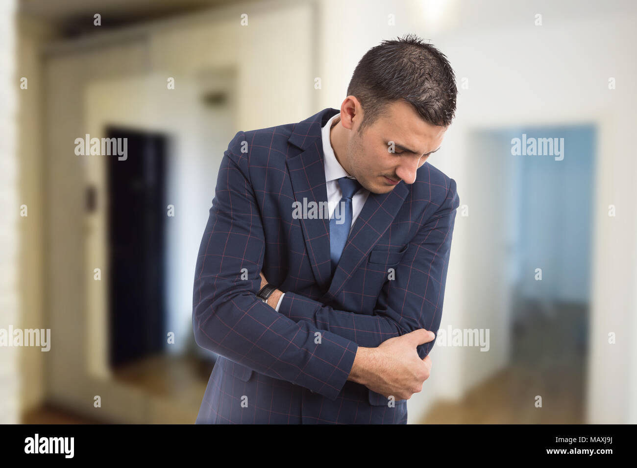 Real estate agent suffering elbow pain as physical injury or health