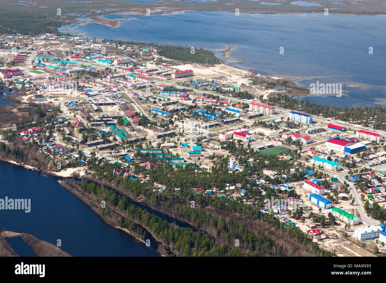 Aerial View of Novoagansk town, Tyumen region, Russia, which located on the bank of the Siberian river Agan in spring. Stock Photo