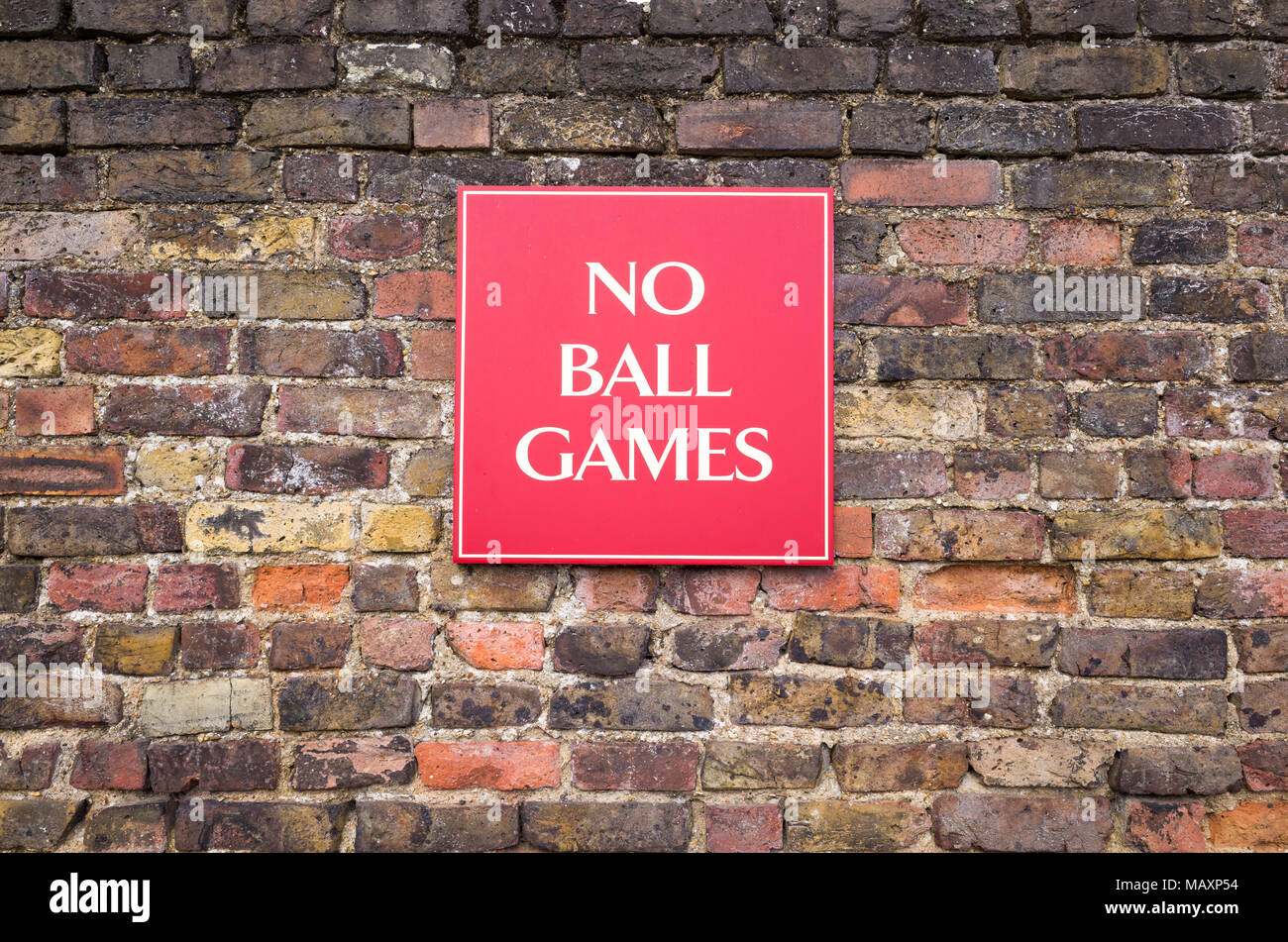 No ball games sign on brick wall, UK Stock Photo