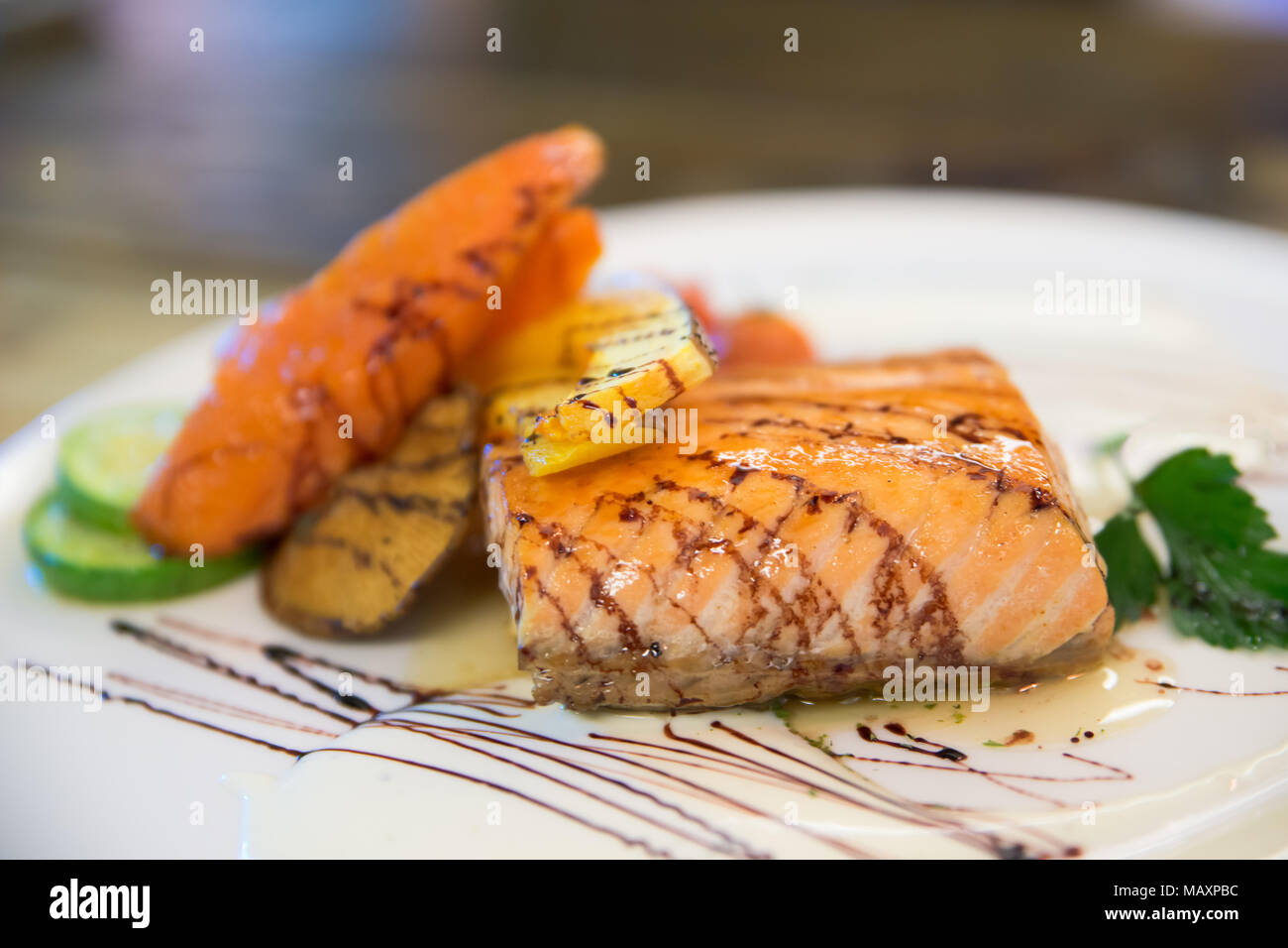 Grilled salmon steak and vegetables in white dish at Japanese food restaurant. Stock Photo