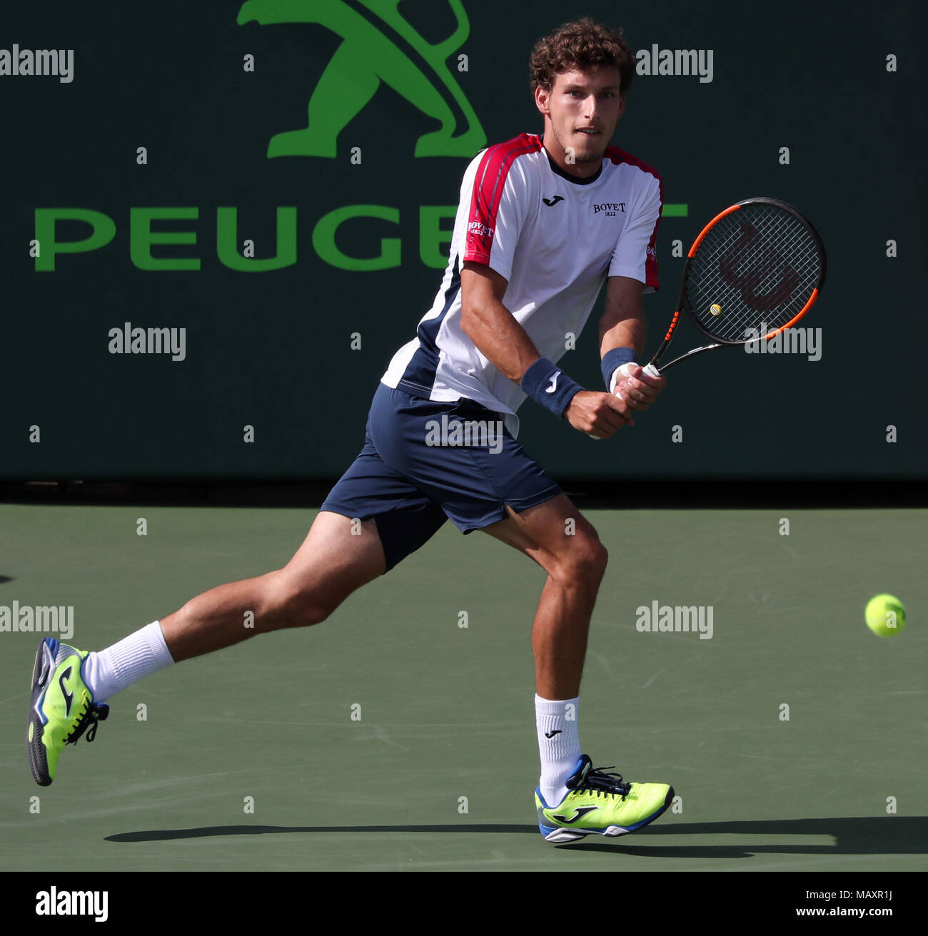 Key Biscayne, Florida, USA. 27th Mar, 2018. Pablo Carreno Busta of Spain plays a backhand against Fernando Verdasco of Spain during a fourth round match of the 2018 Miami Open presented by Itau professional tennis tournament, played at the Crandon Park Tennis Center in Key Biscayne, Florida, USA. Mario Houben/CSM/Alamy Live News Stock Photo